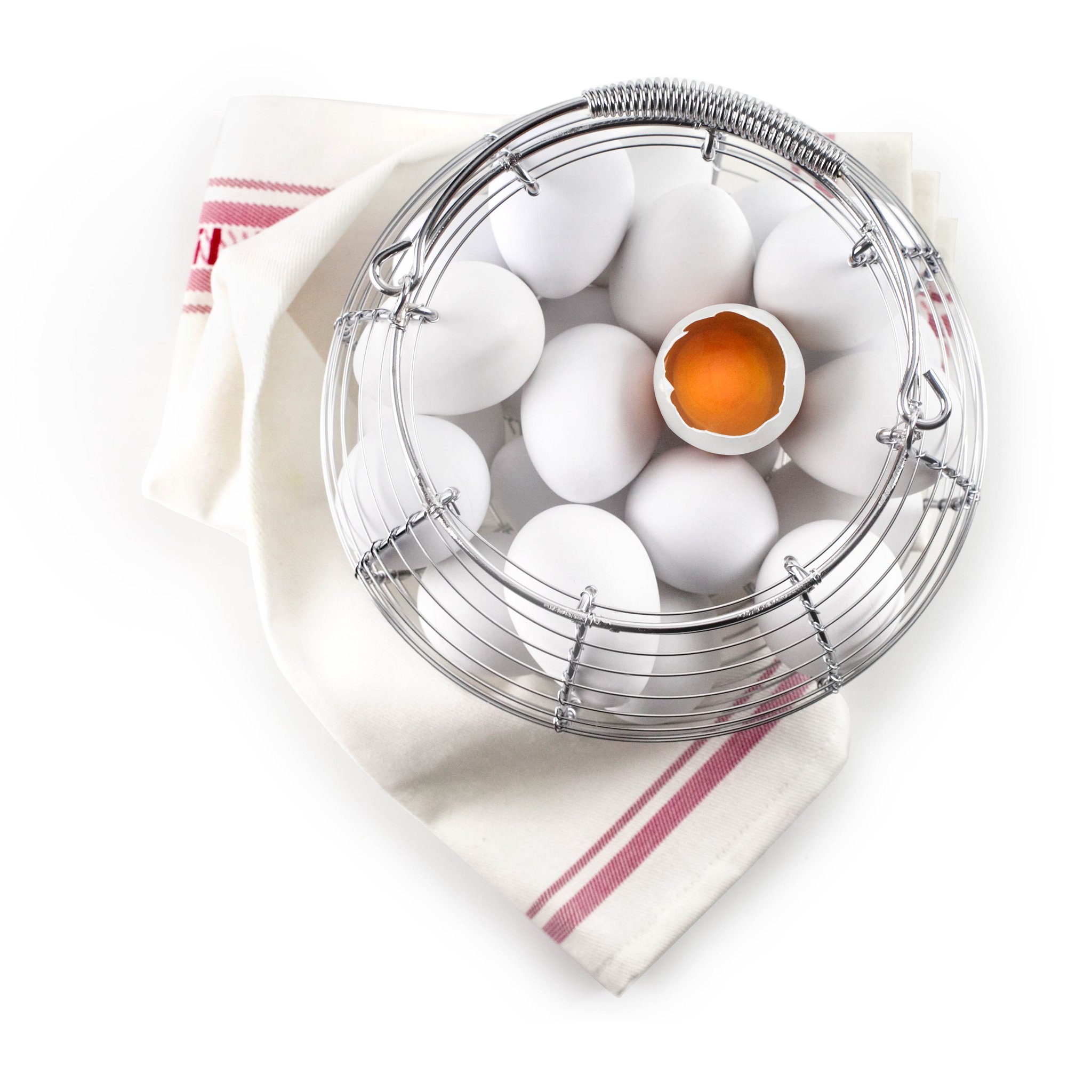 Egg basket seen from above on a tea towel, filled with eggs