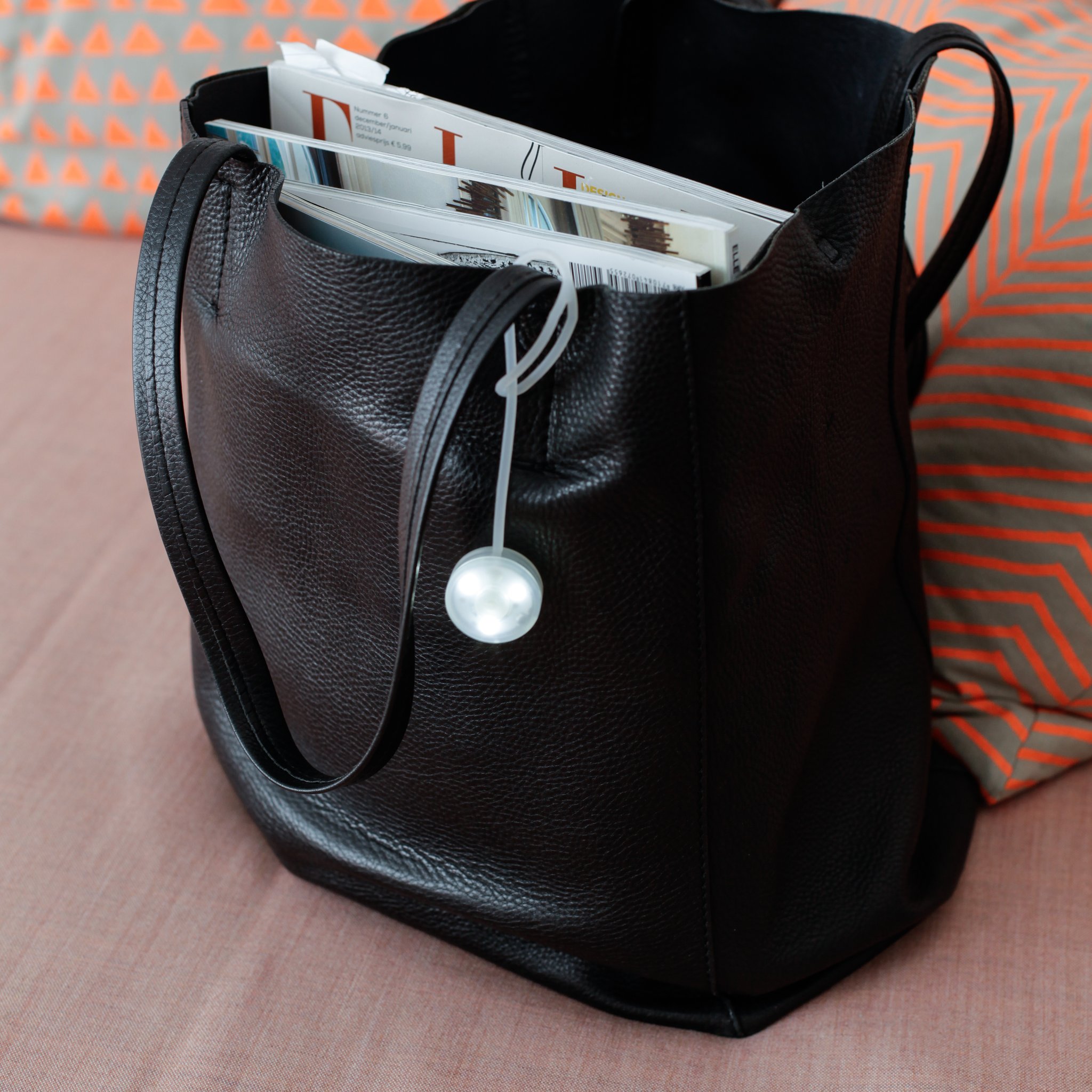 Purse light hanging inside a black leather bag