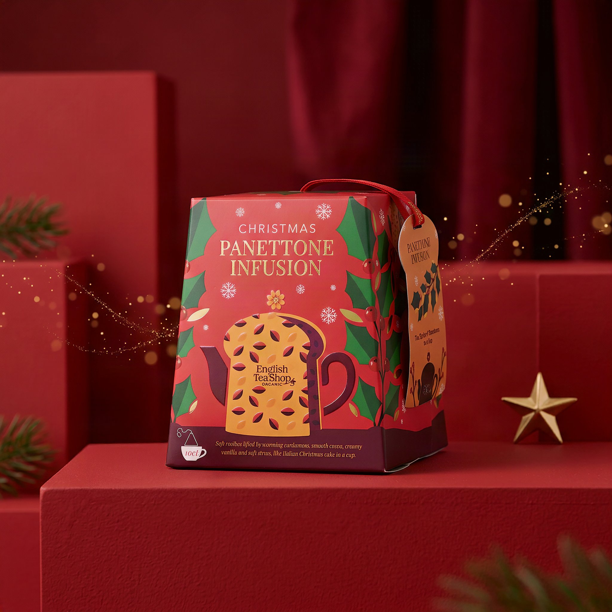 Coffret de thé Panettone sur un socle rouge avec étoile dorée et traînée scintillante