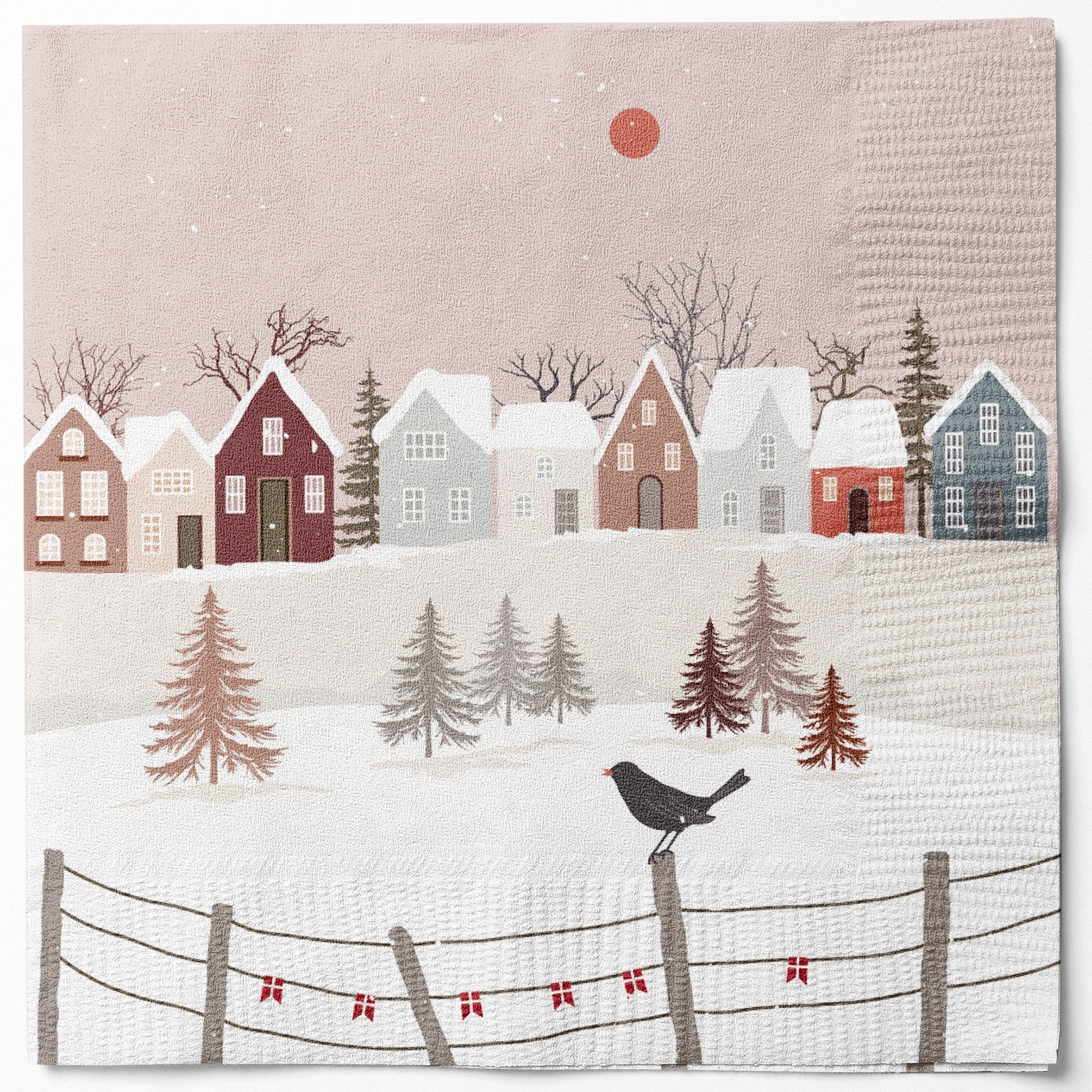 Papierserviette mit bunten Häusern, Schneedächern, Zaun mit roten Schleifen und Amsel