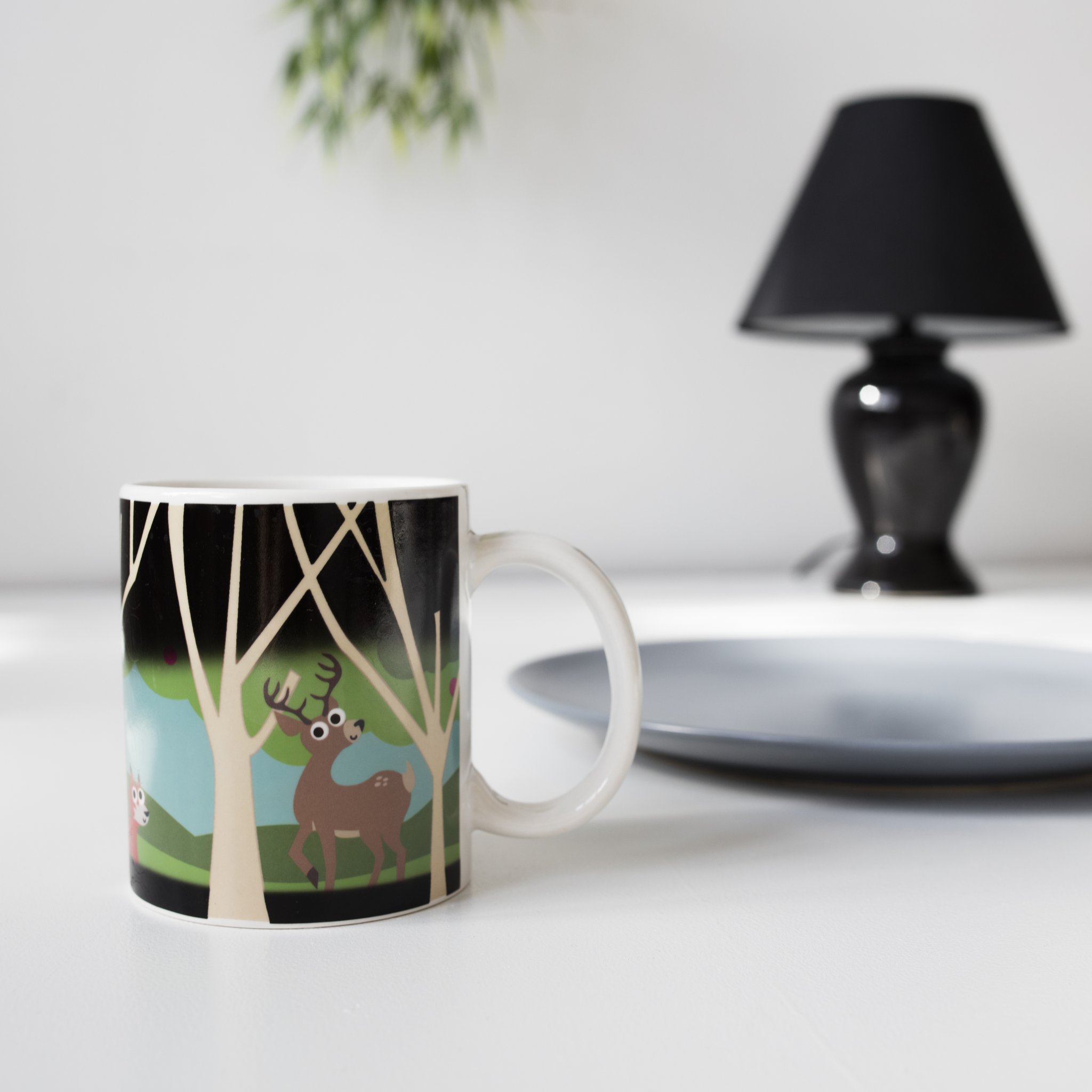 Woodlands Heat Change Mug – landscape lifestyle on table