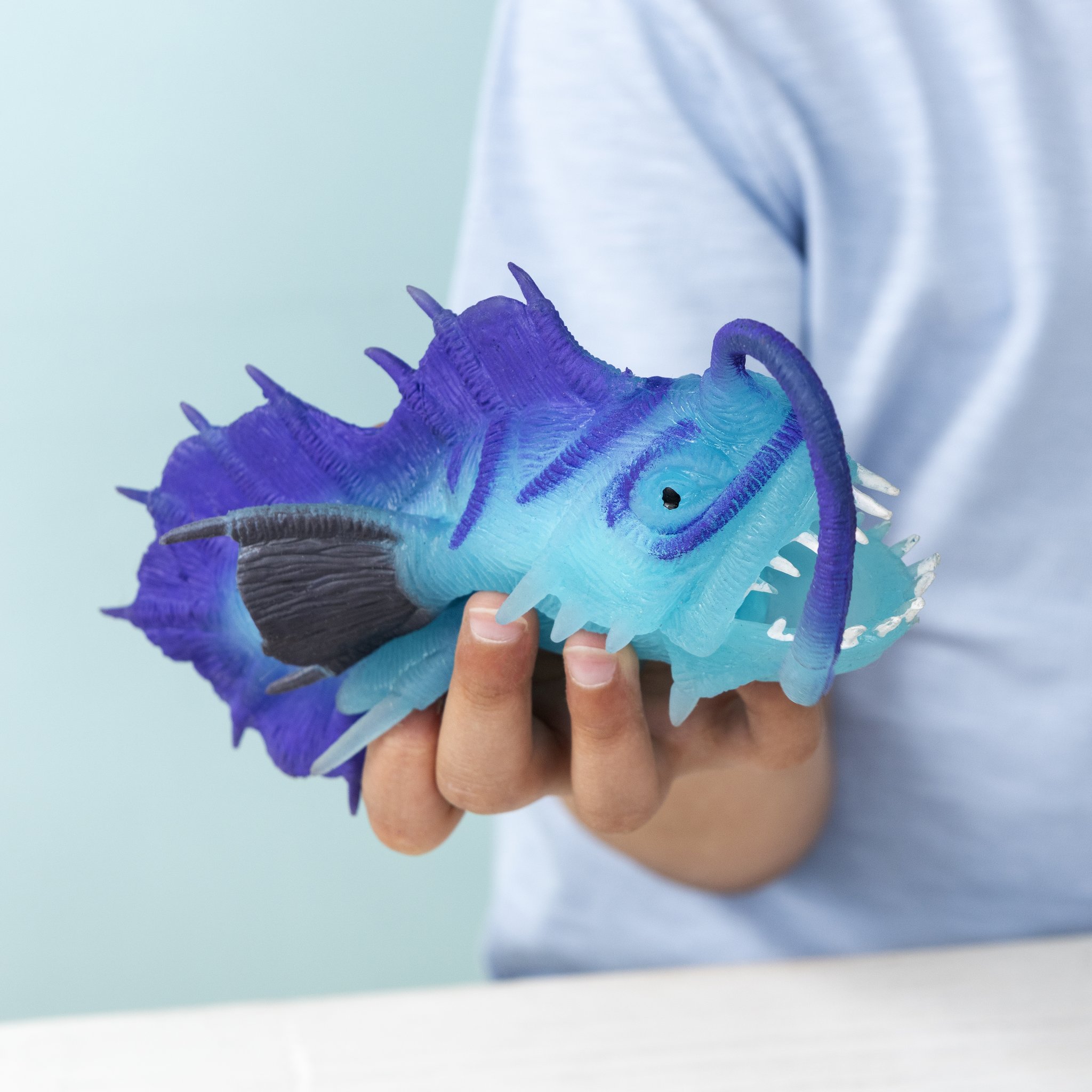 Glow in the dark anglerfish stress ball in a child's hand