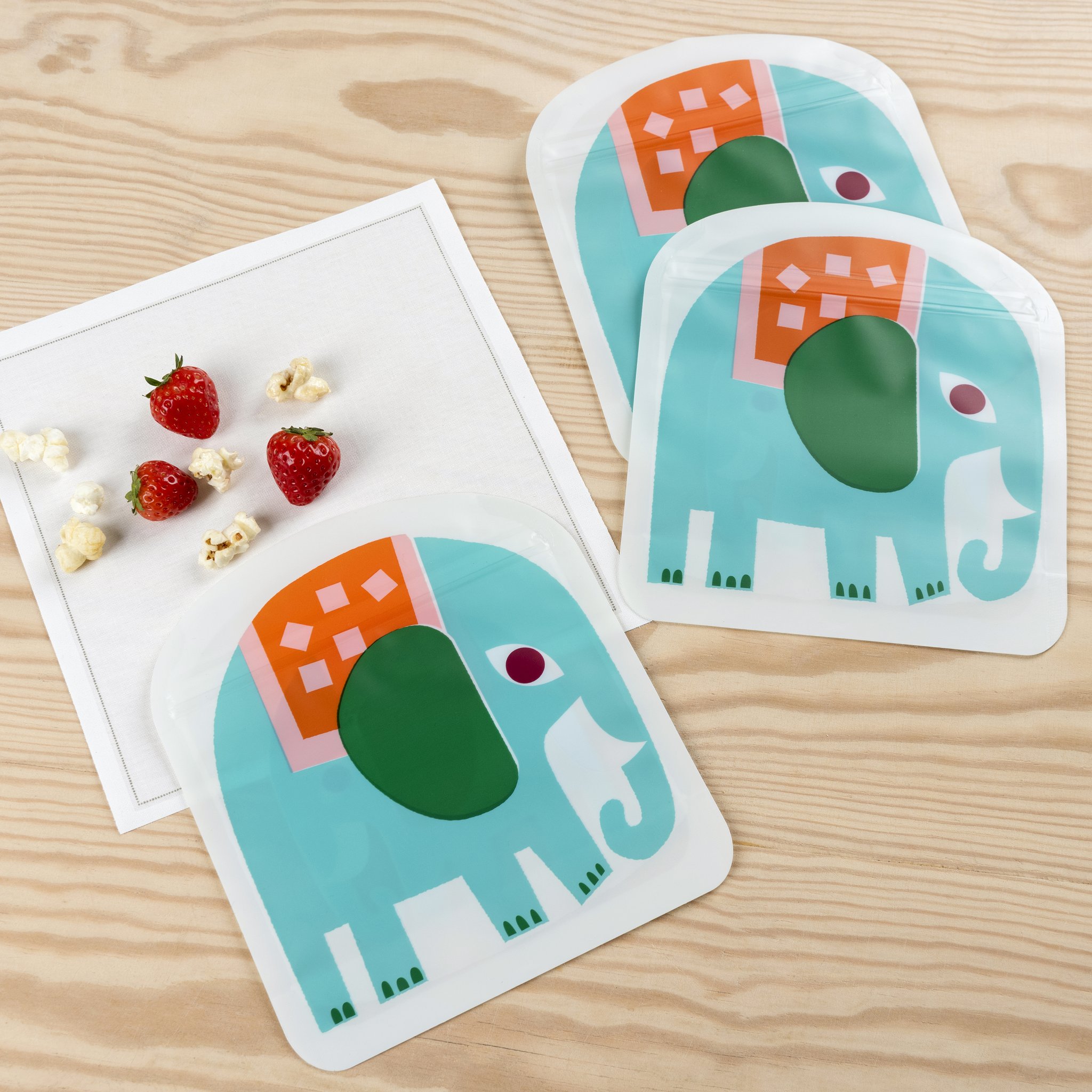 Elephant snack bags with strawberries and popcorn on the table