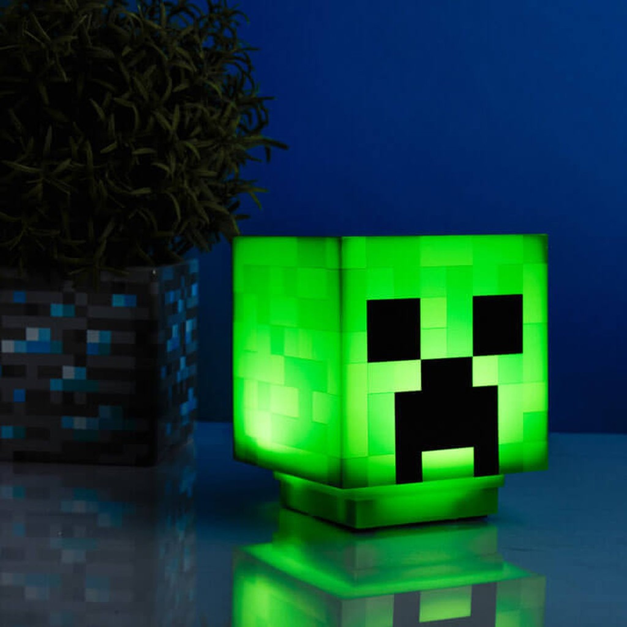 Creeper lamp glowing next to a house plant