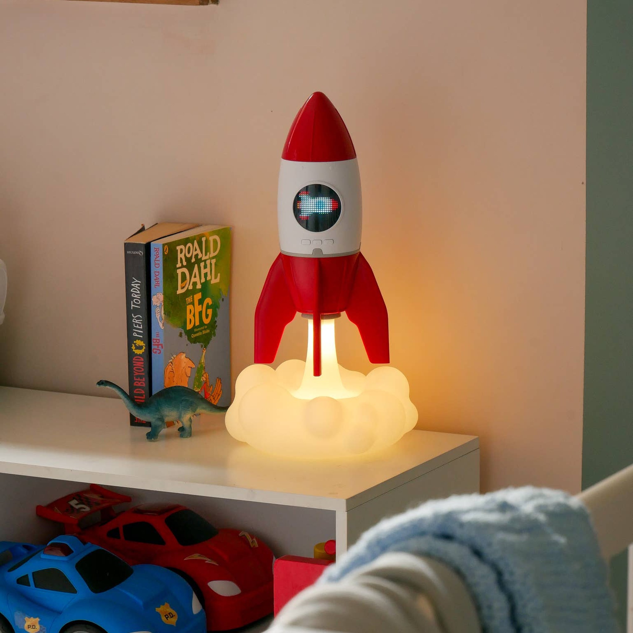 Rocket on a shelf with a shooting star glowing in the porthole