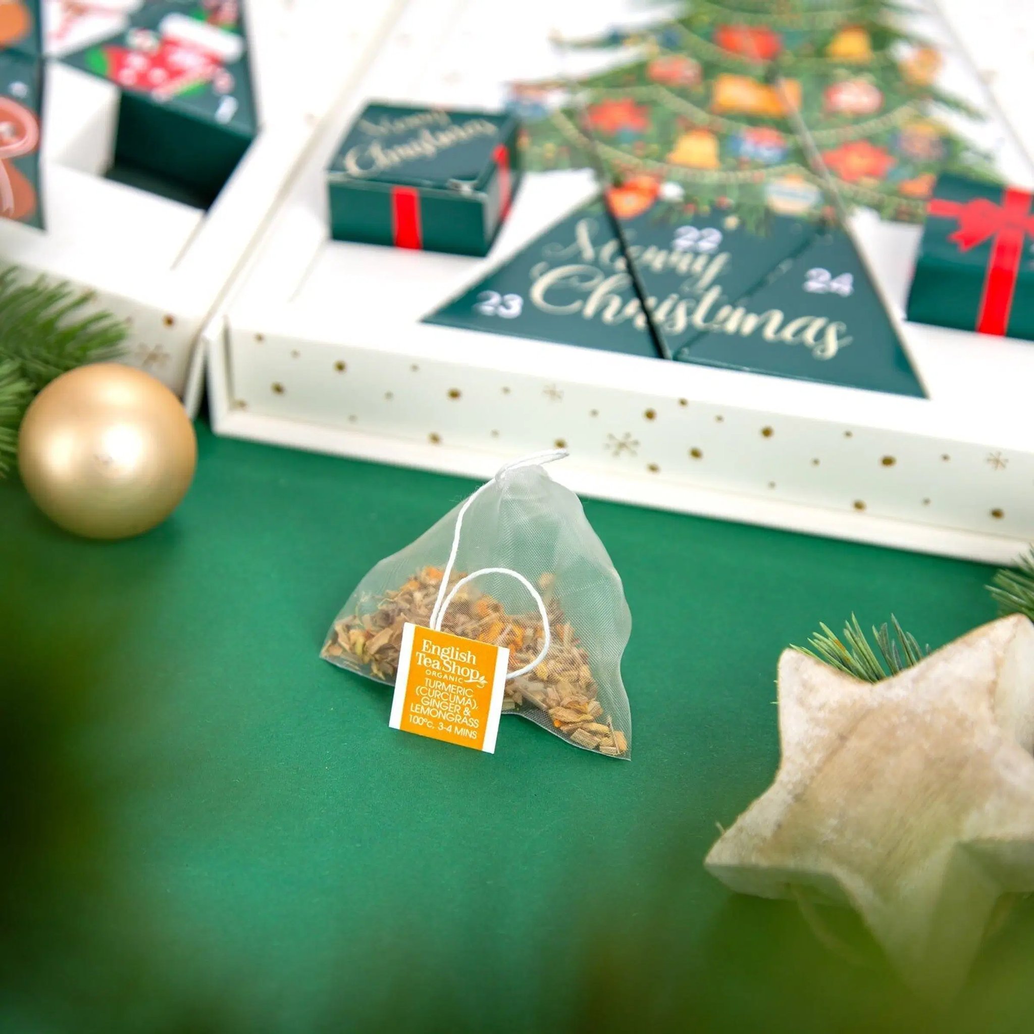 English Tea Shop pyramid tea bag in front of the tea advent calendar with its Merry Christmas doors