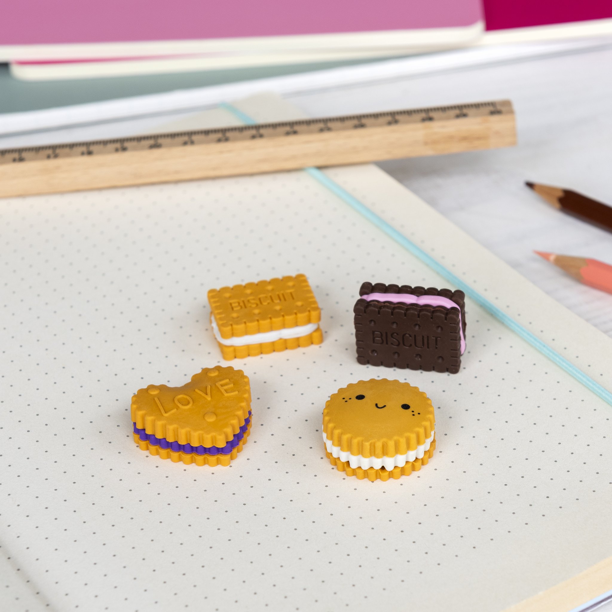 Gomme biscotto su un quaderno puntinato accanto a righello e matita
