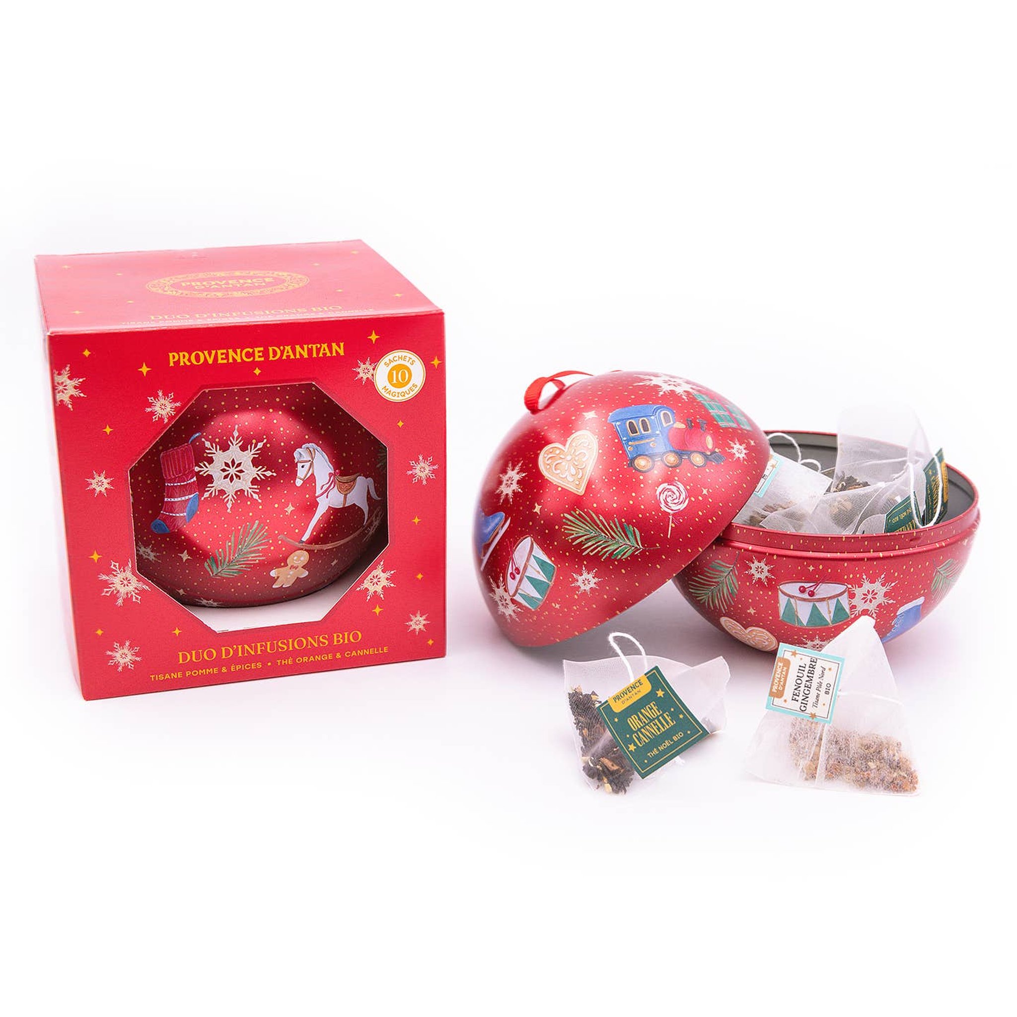 Geöffnete Metallkugel mit Pyramidenbeuteln Bio-Tee und Kräutertee neben dem Karton