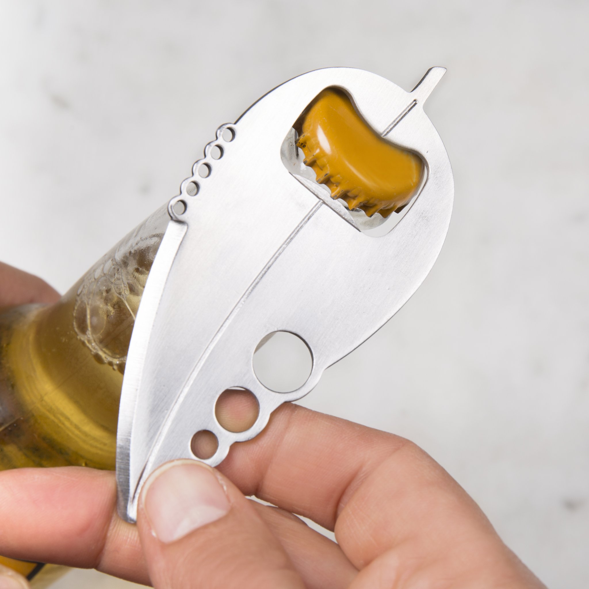 Kitchen multitool opening a beer bottle