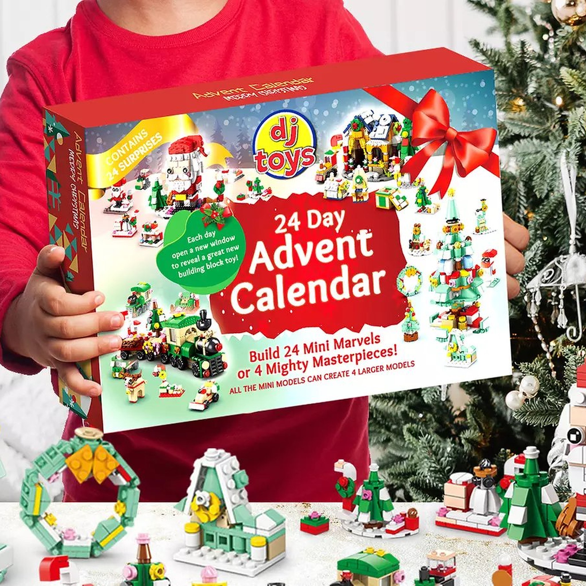 Child holding the building block advent calendar by the Christmas tree with mini models