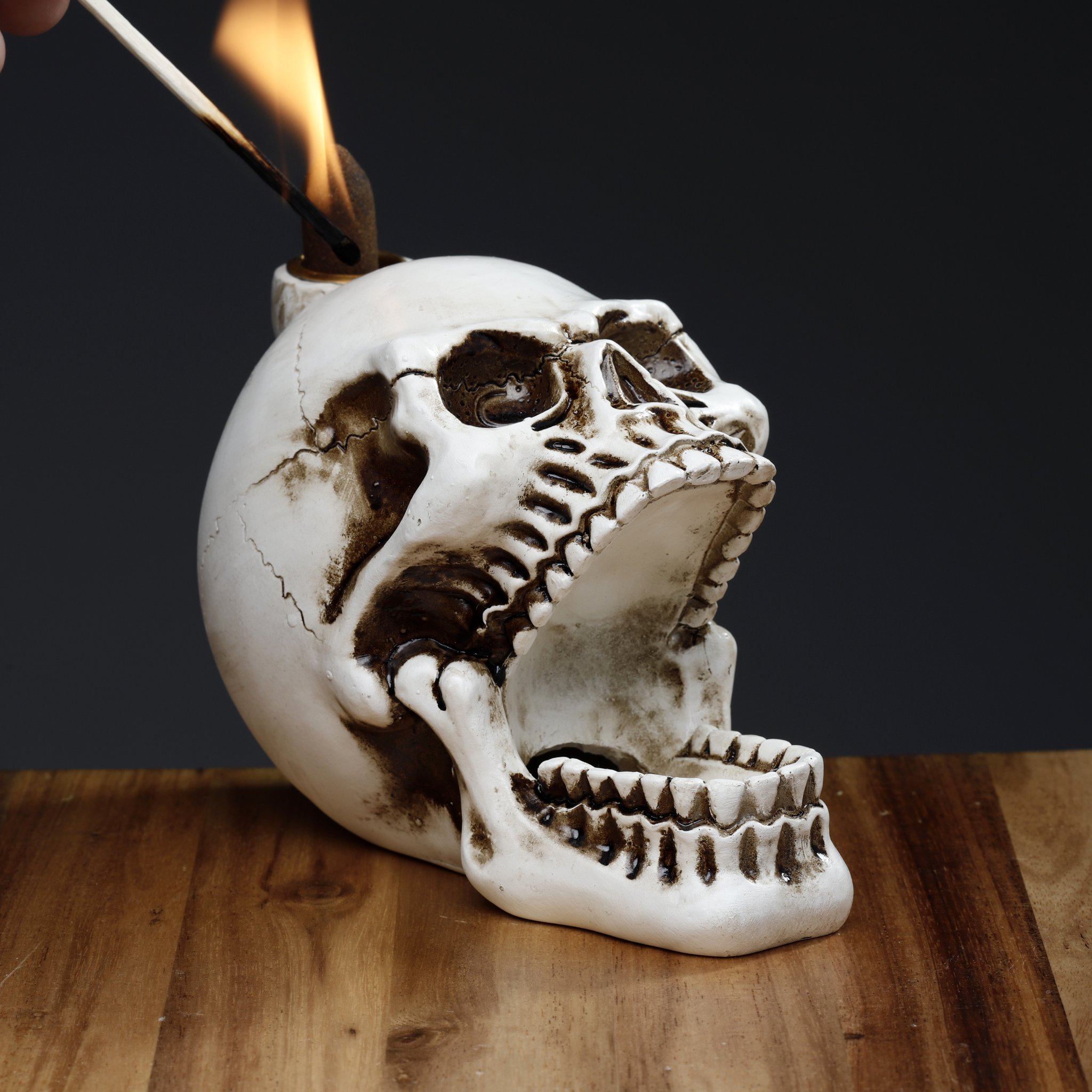 Incense cone being lit on the skull