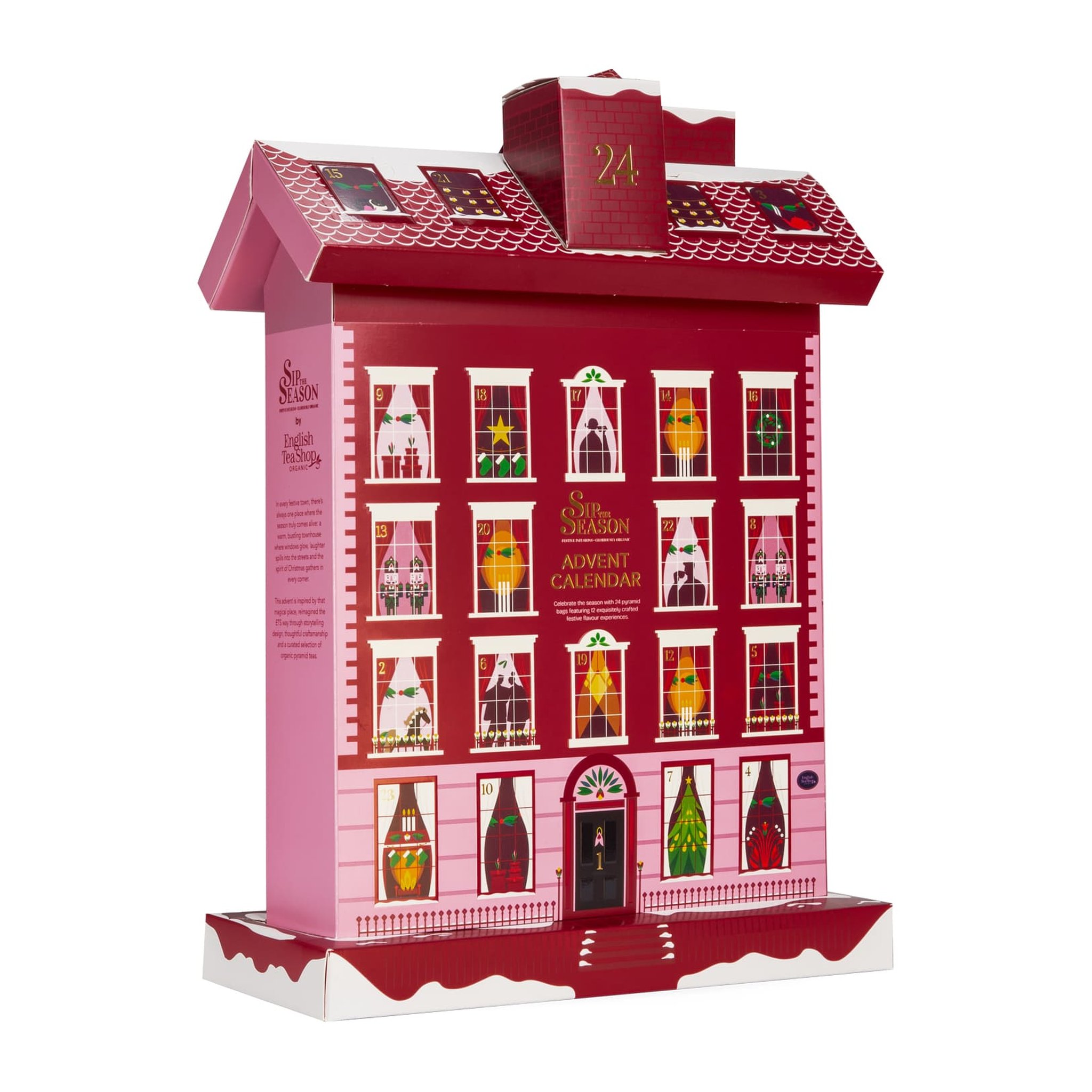 Calendrier de l'Avent au thé en forme de maison vu de biais, avec paroi latérale rose et toit enneigé