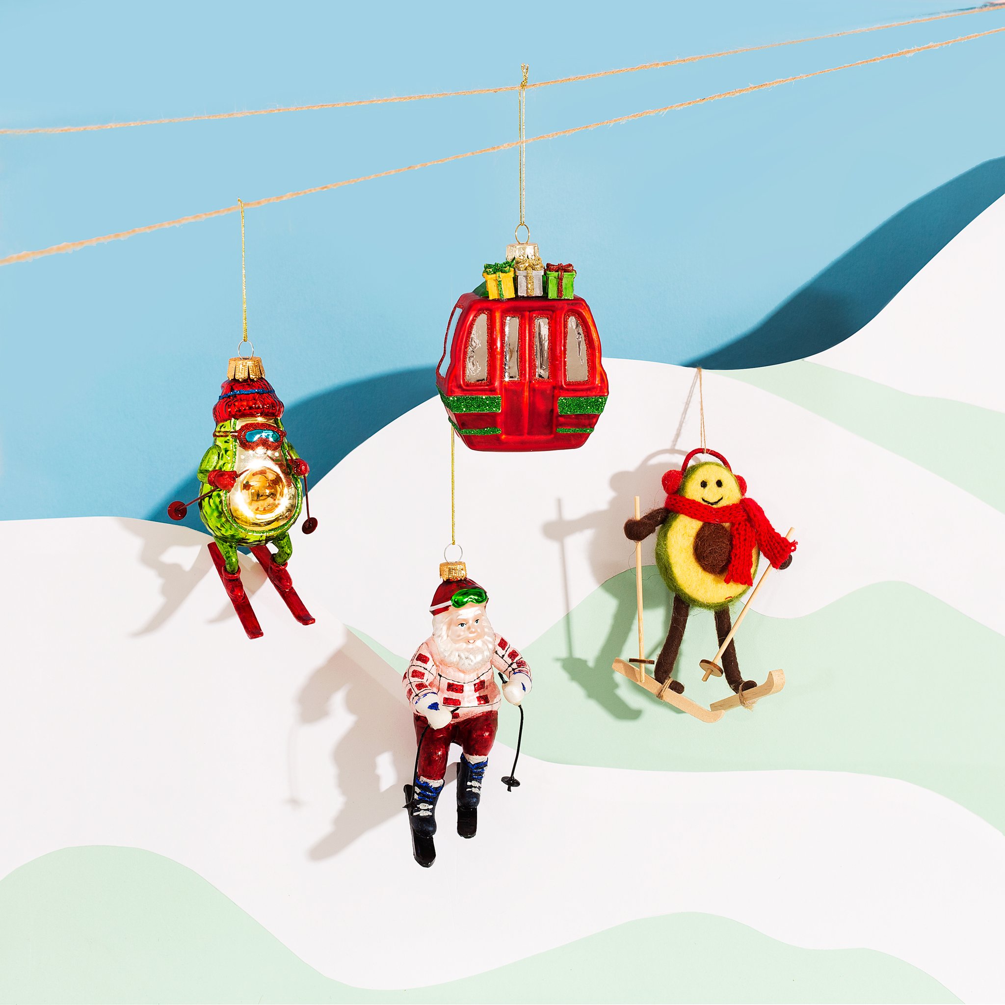 Gondola Christmas decoration with Santa and chicken skier ornaments in the winter scene