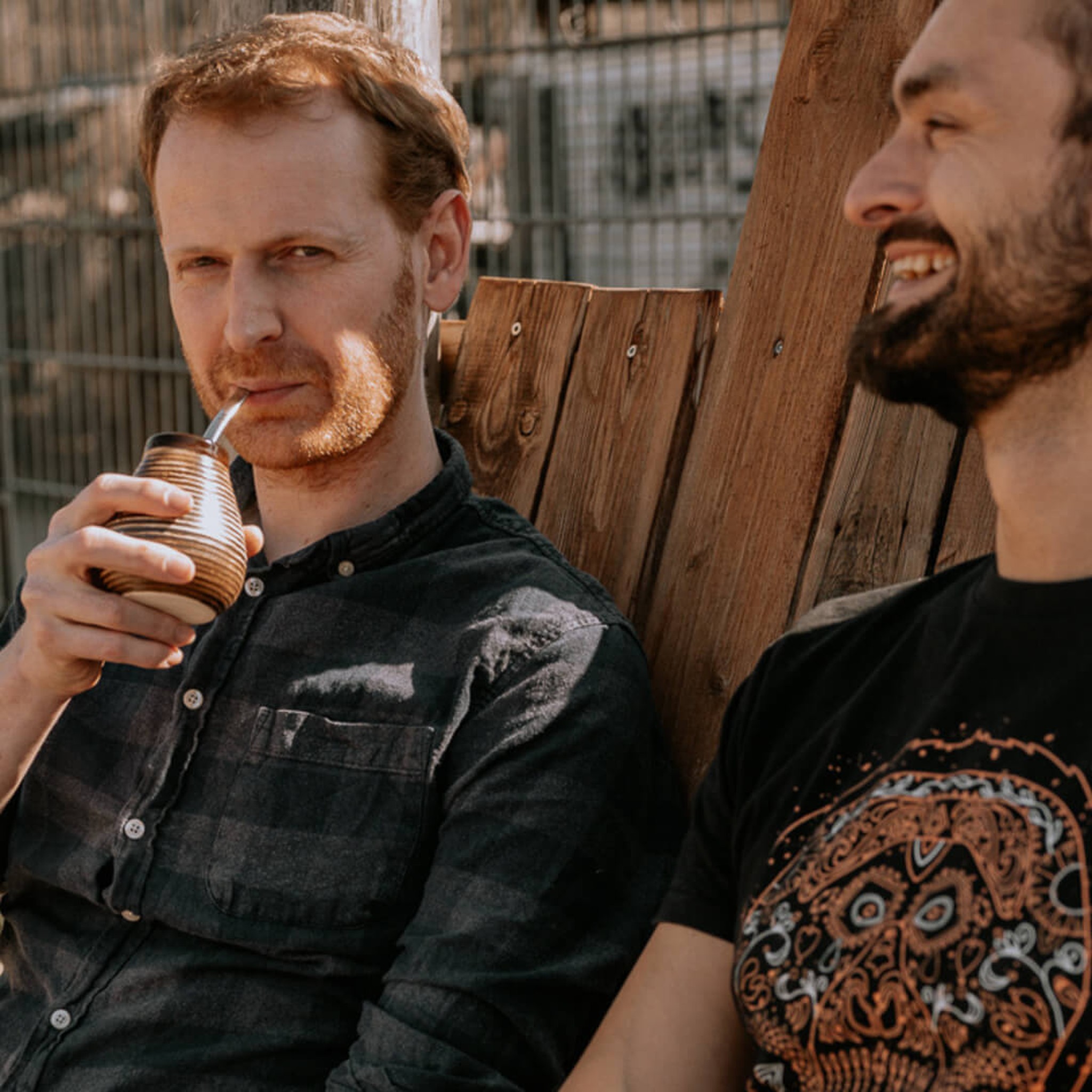 Two people enjoying mate tea together from Caámate ceramic cups