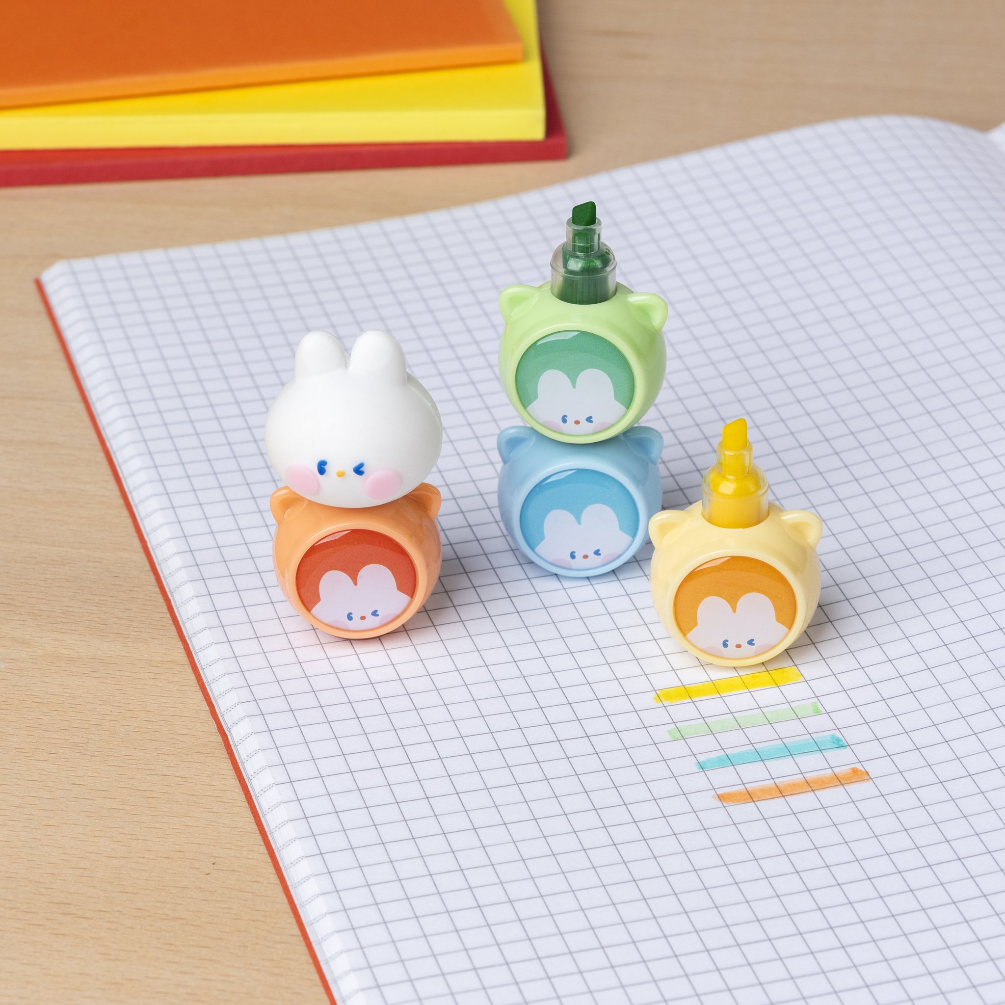 Stackable bunny highlighters on a squared pad with colourful marks