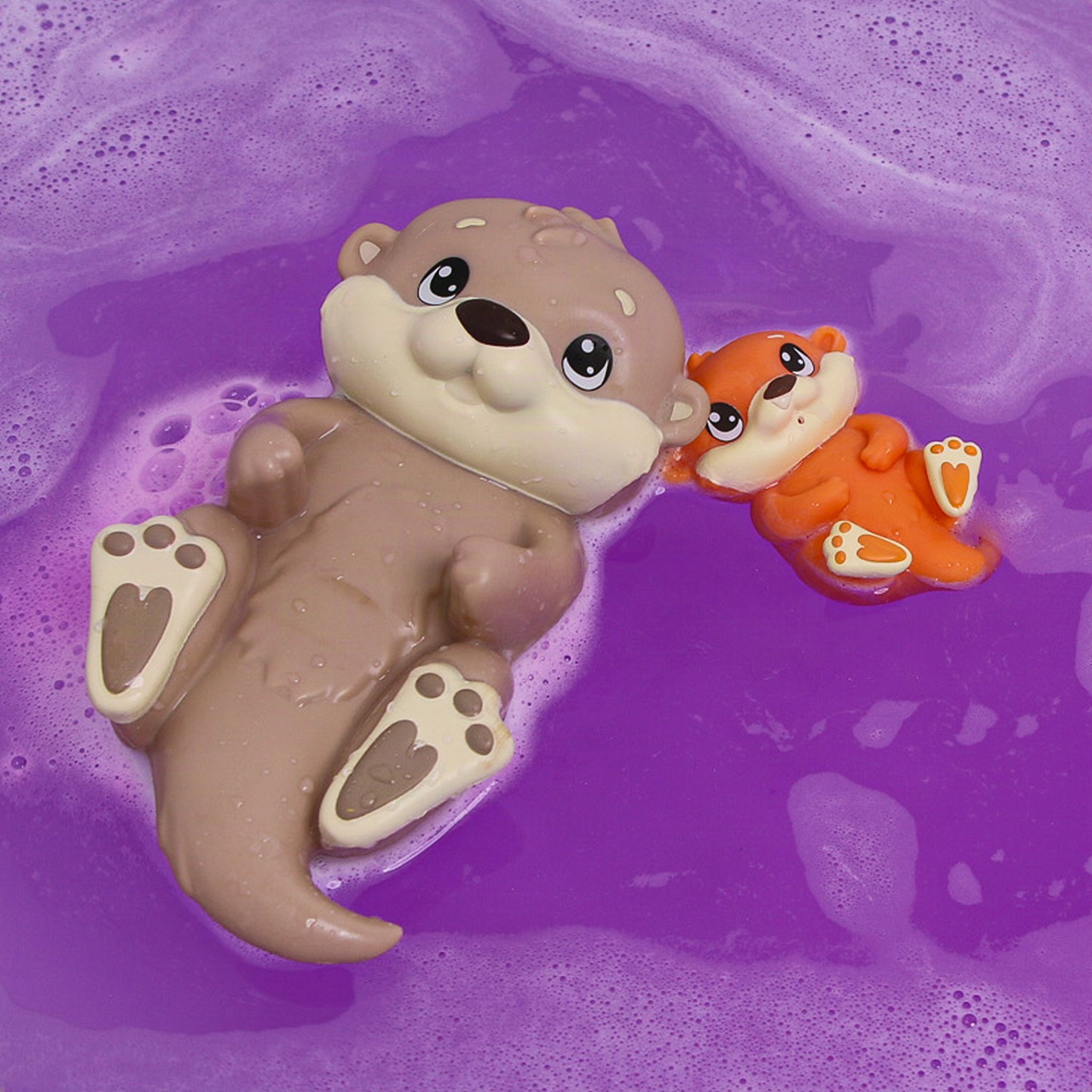 Mother otter floating on her back in purple bath water, the baby otter beside her