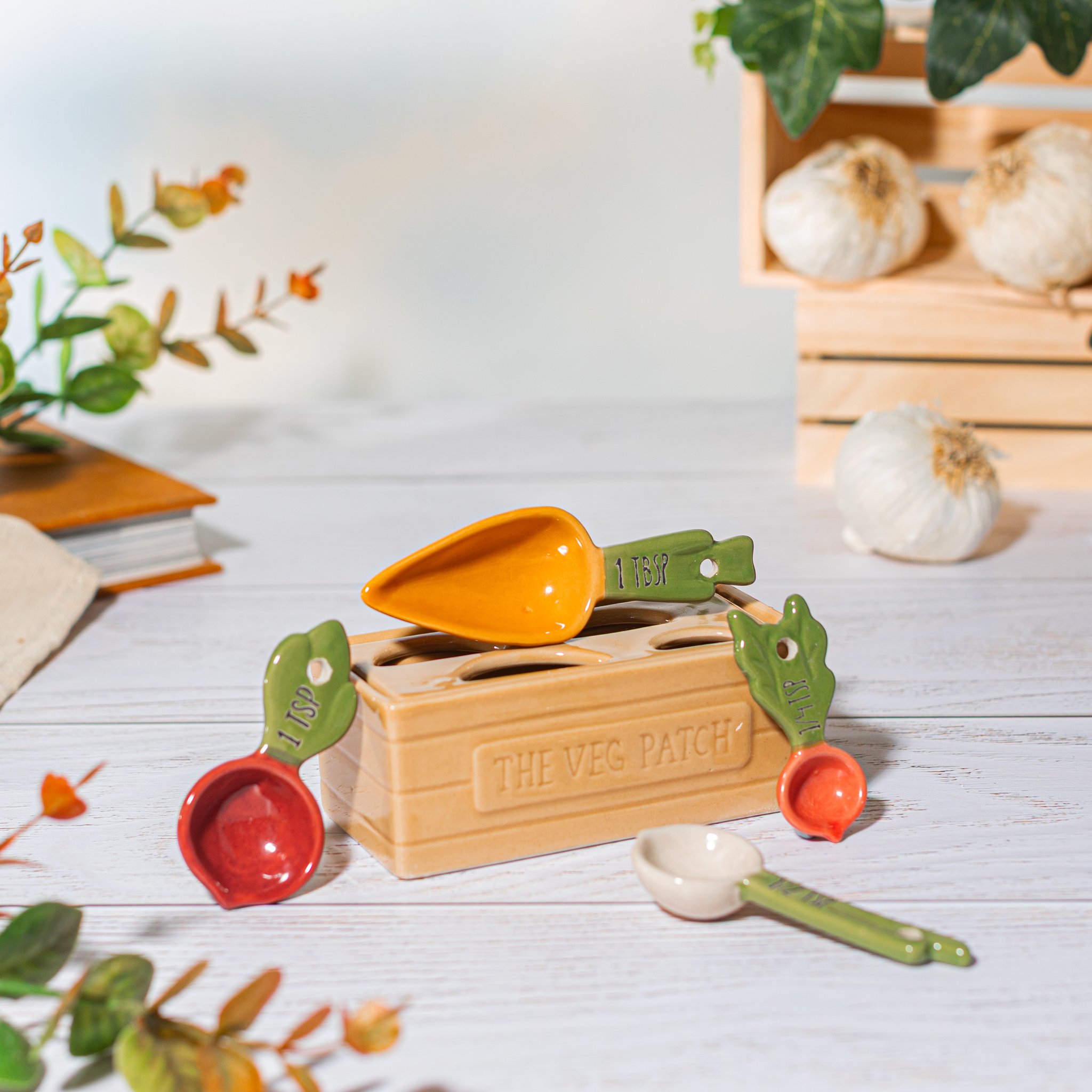 Vegetable measuring spoon set in veg patch design on a wooden kitchen table