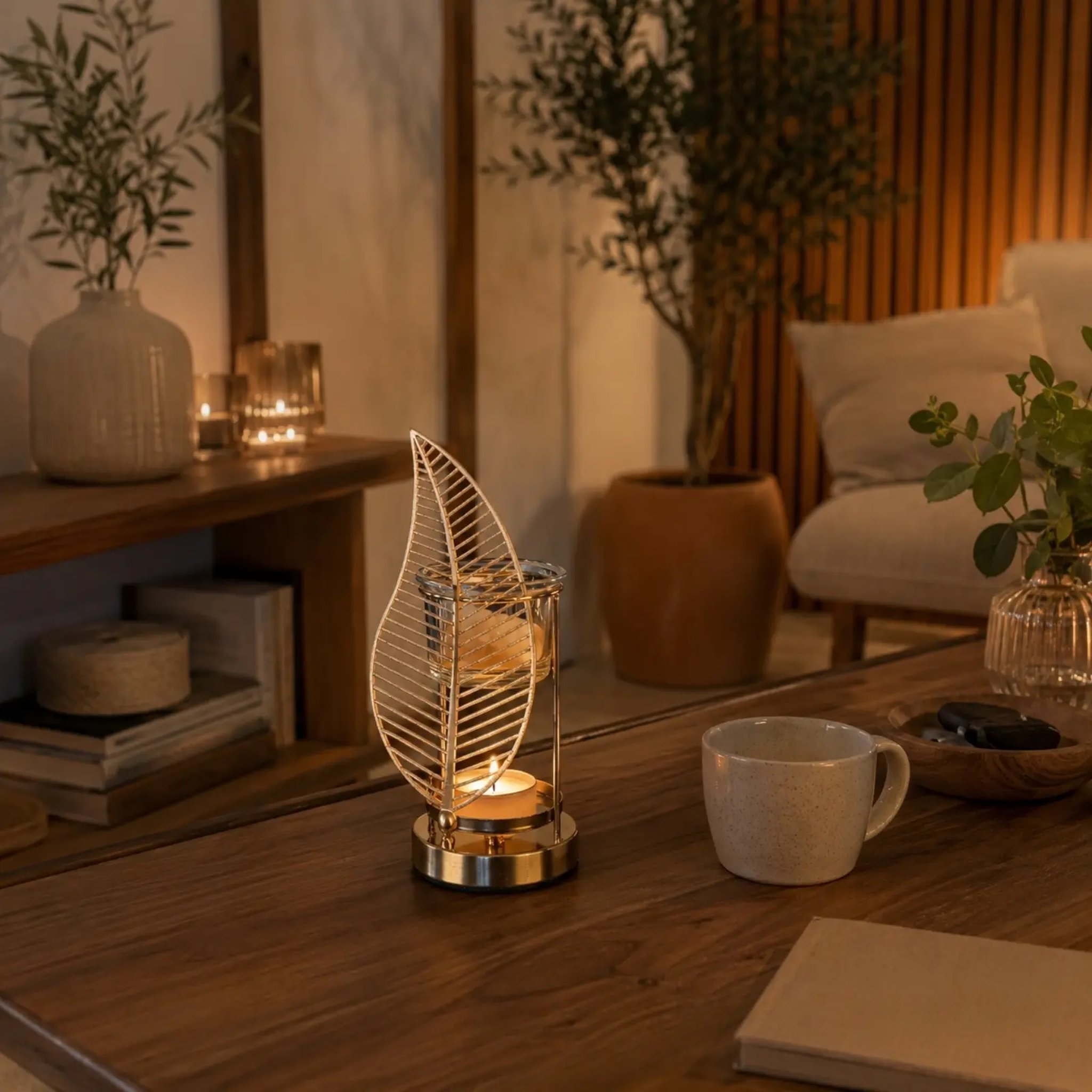 Glowing palm leaf oil burner on a living room table beside a mug