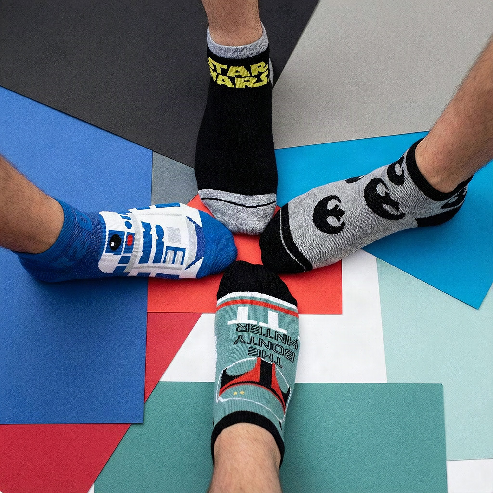 Star Wars ankle socks with R2-D2 and Boba Fett worn on a colourful surface