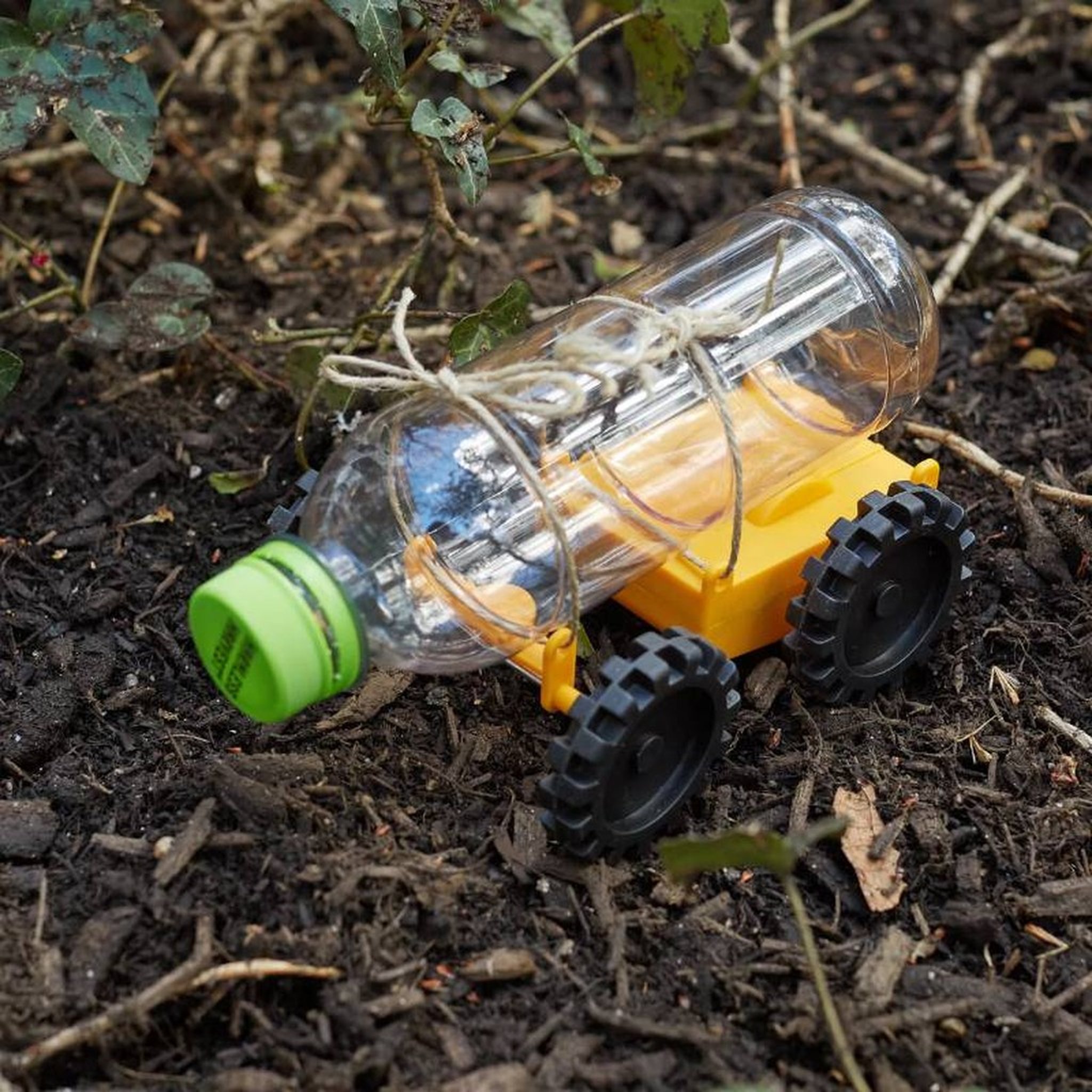 Self-built car with a PET bottle as body on the soil