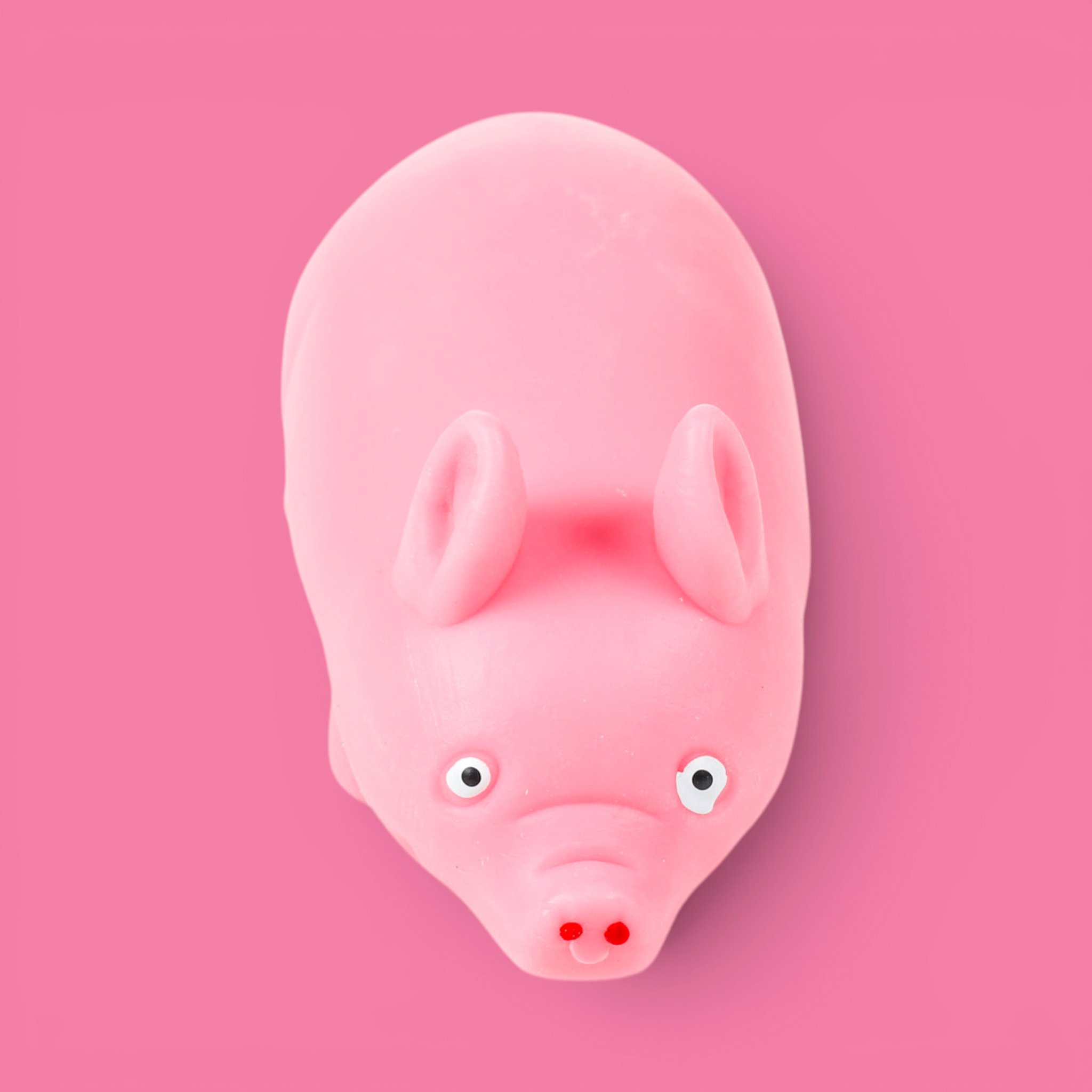 Cochon anti-stress rose vu de dessus sur fond rose
