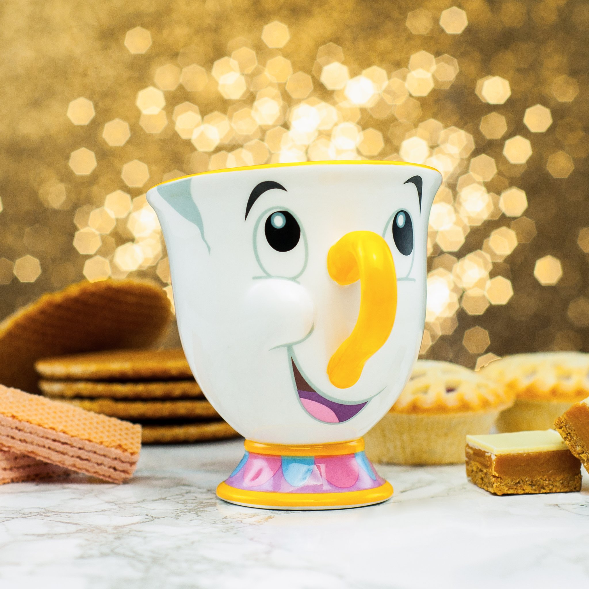 Chip mug in front of golden bokeh lights with biscuits