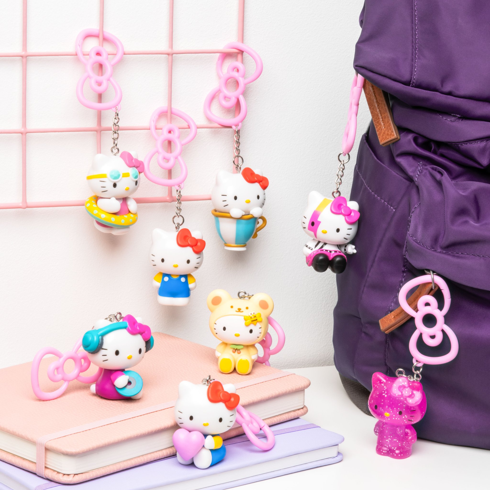 Hello Kitty charms on a purple backpack