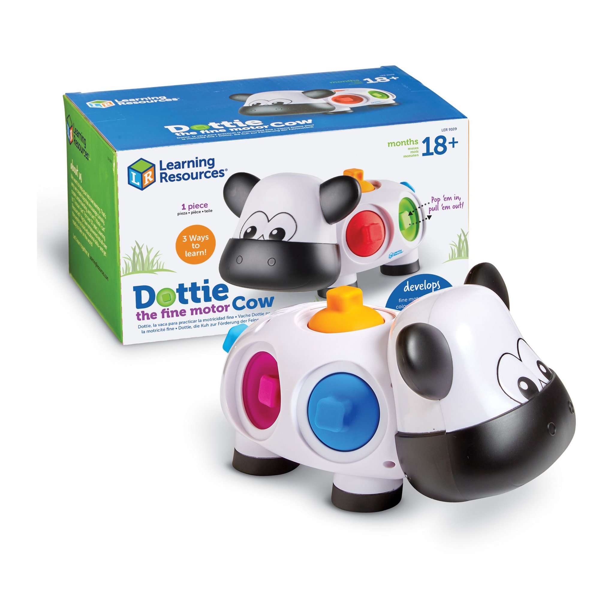 La vache Dottie avec ses points rose et bleu devant sa boîte Learning Resources