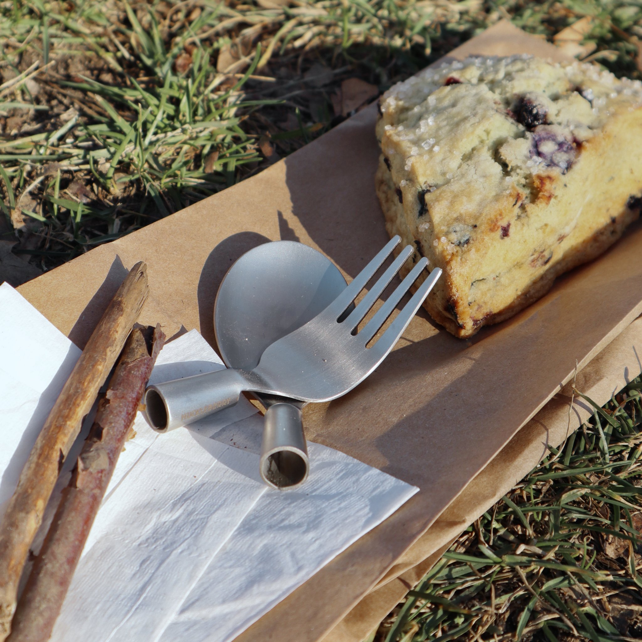 Besteck-Set mit Stöcken als Griff auf Papier beim Picknick