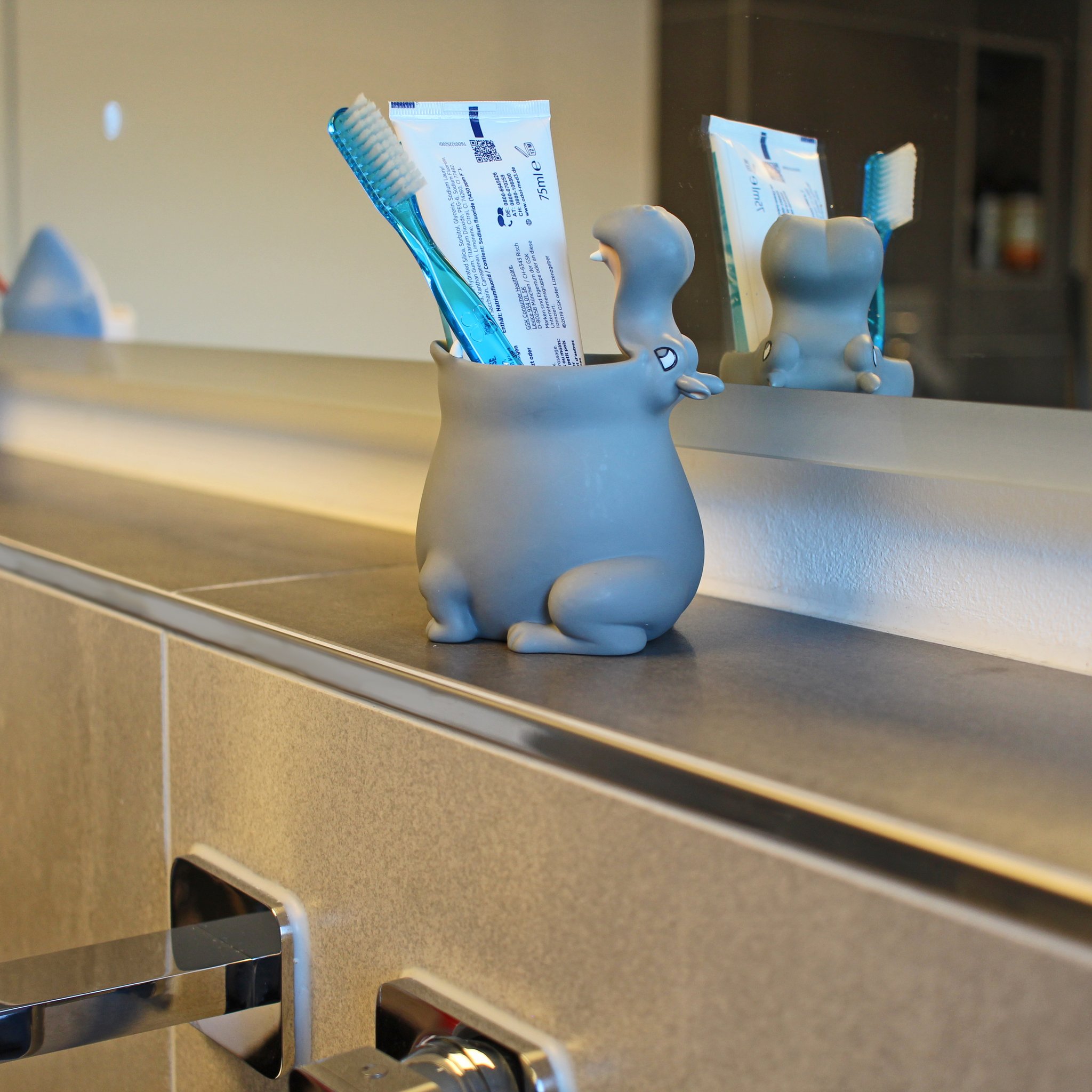 Hippo toothbrush tumbler with toothbrushes at the sink