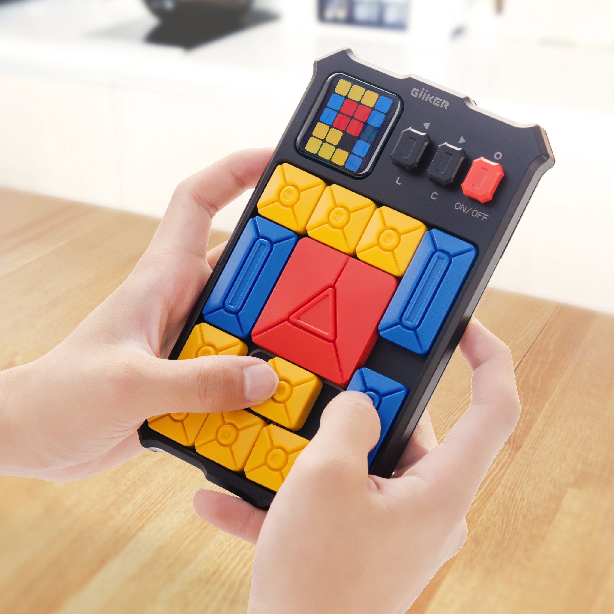 The compact Super Slide sliding puzzle held in two hands, blocks within easy reach.