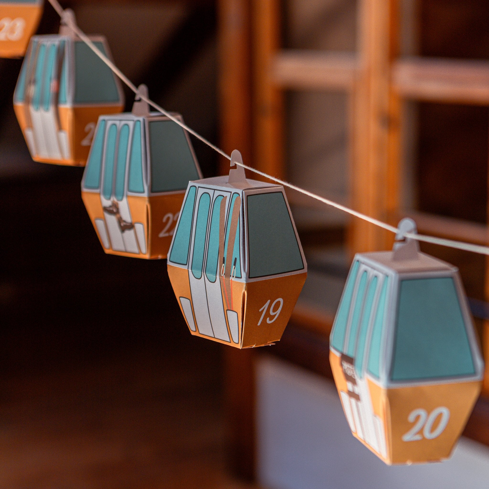 Cable Car Advent Calendar Gold-Yellow by roadtyping – hanging numbered gondolas in warm light