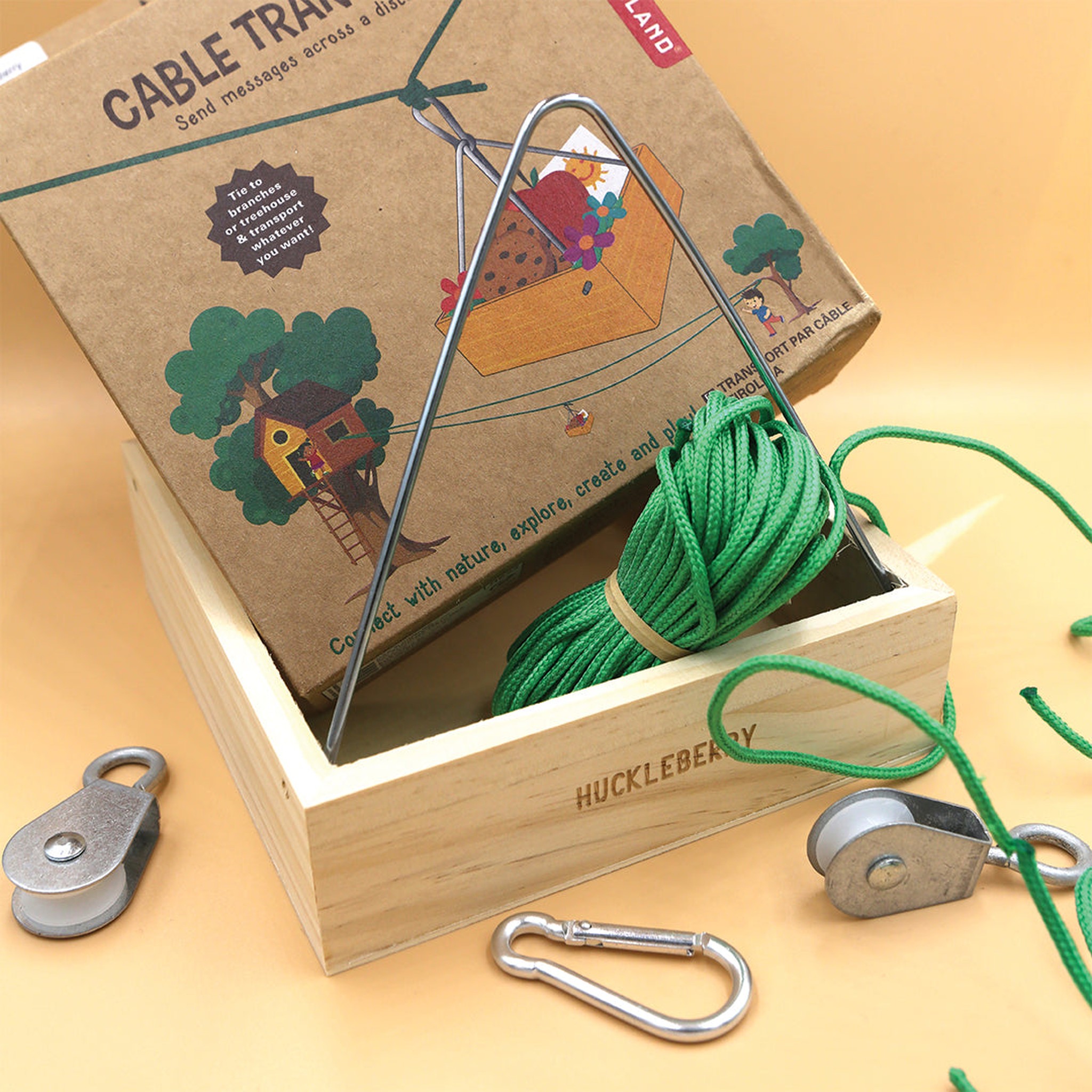 Huckleberry Seilbahn-Set komplett ausgelegt — Gondel, Seil, Rollen und Karabiner neben Verpackung