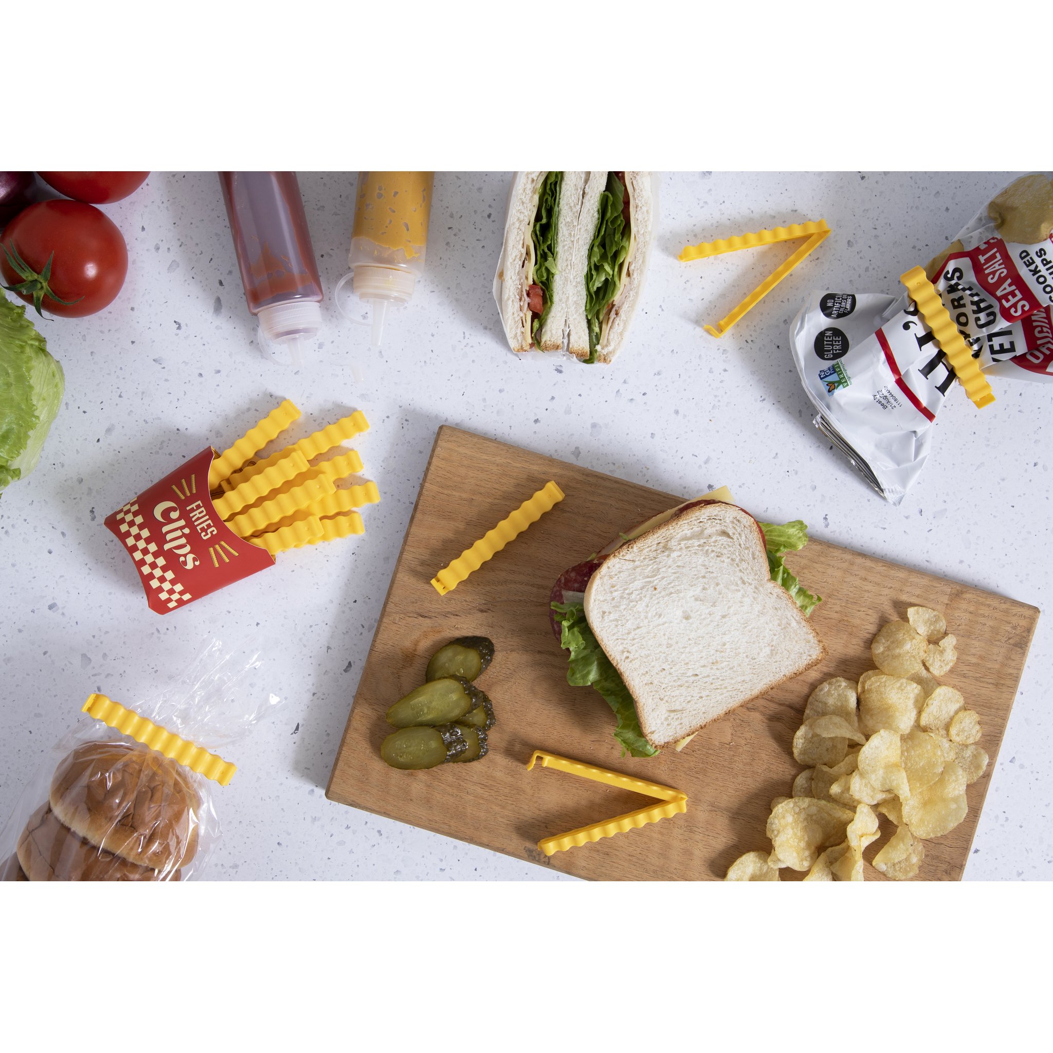 Pommes Tütenklammern Lifestyle mit Sandwich und Chips auf Holzbrett