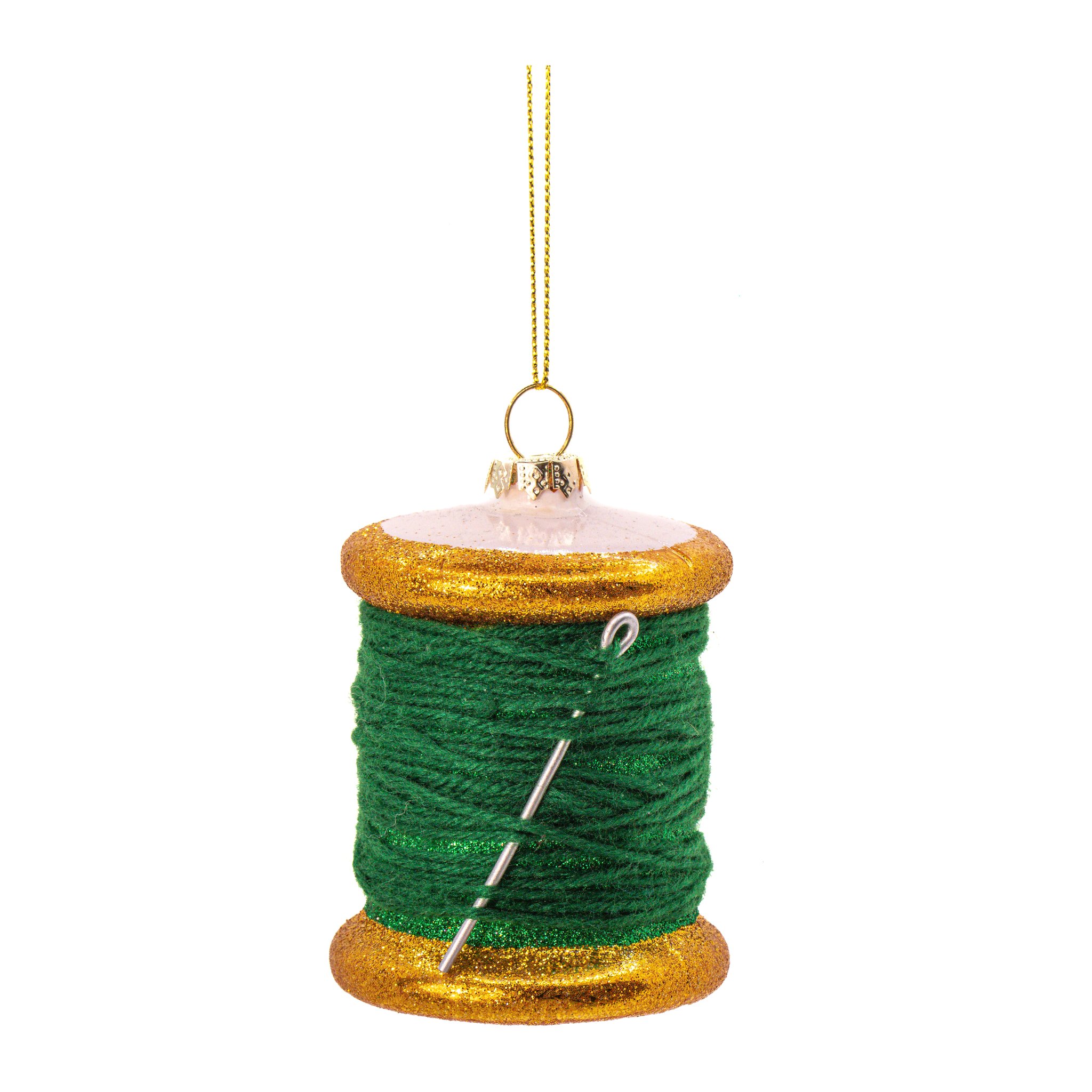 Grüne Garnspule aus Glas mit Nähnadel und goldenen Rändern