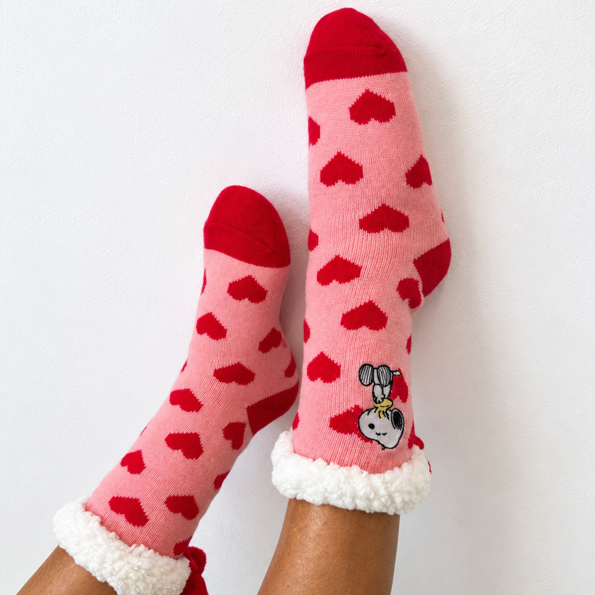 Rosa Kuschelsocken mit roten Herzen und Plüschrand an den Füssen