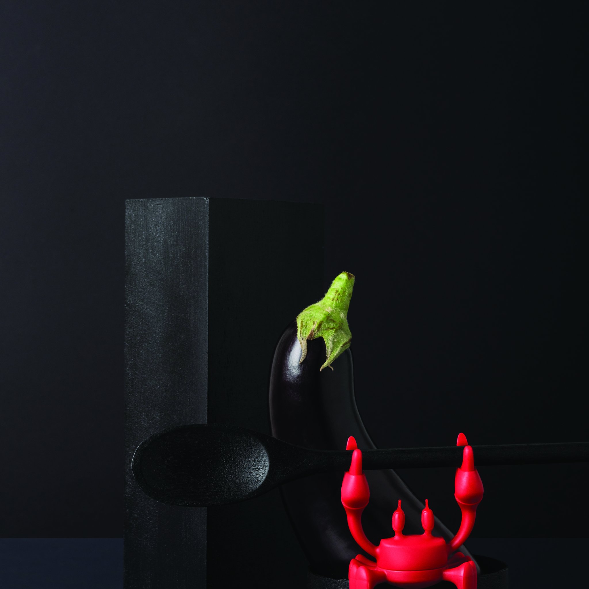 Red crab with a ladle next to an aubergine