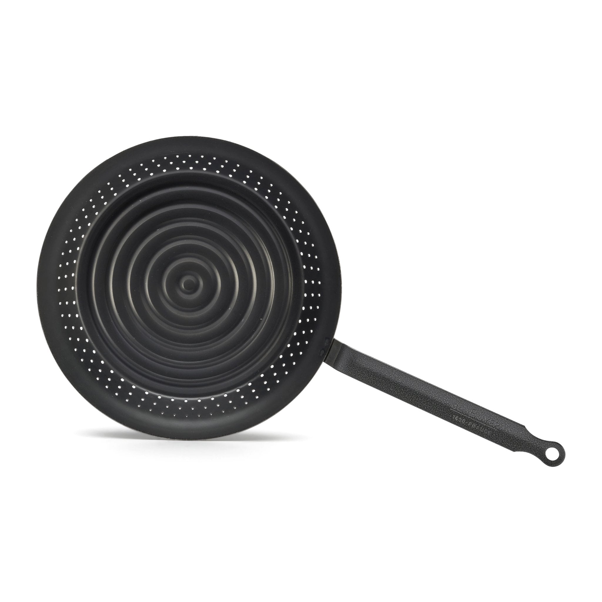 Top view into the chestnut pan showing the concentric grooves and the ring of holes