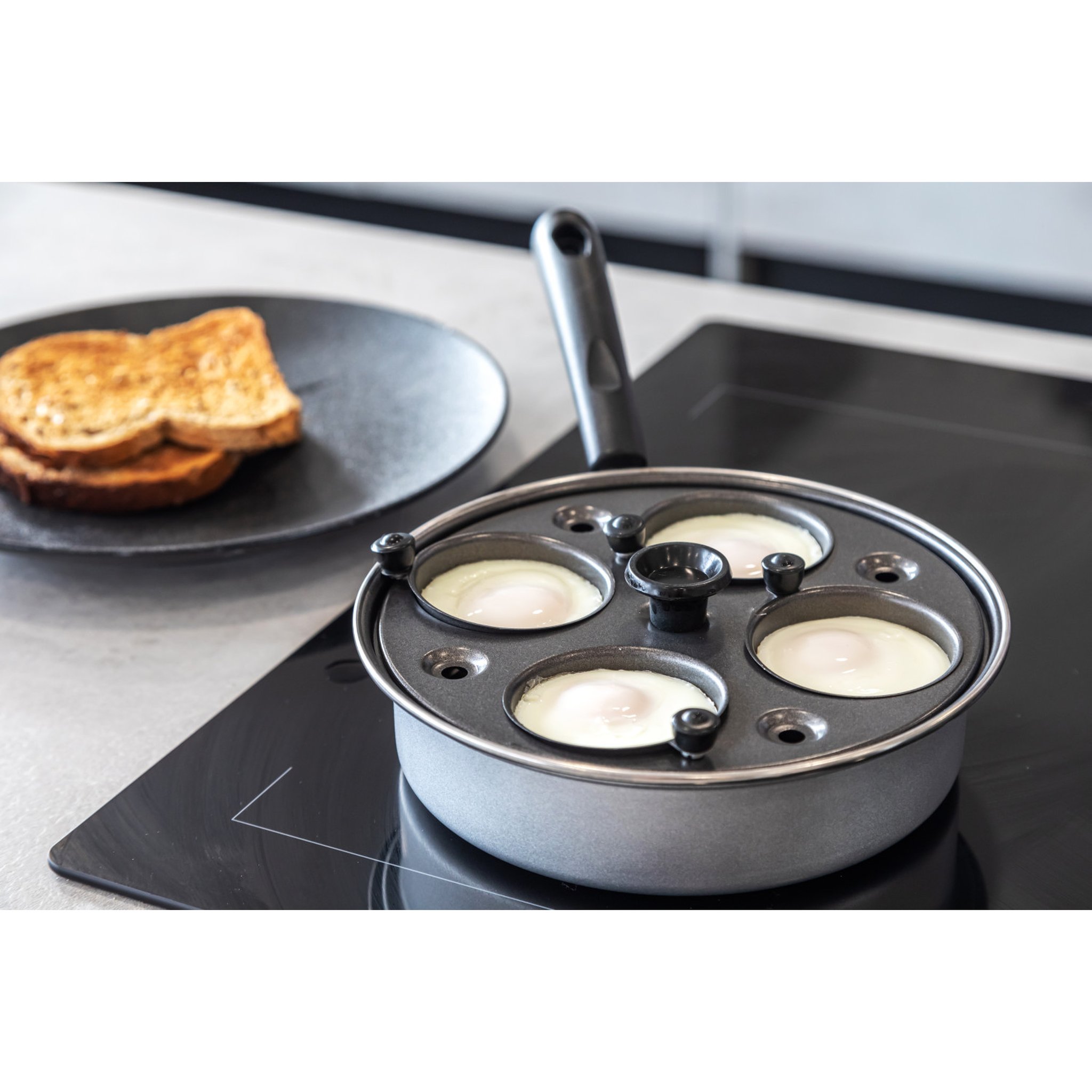 Poached eggs in pan close-up with toast