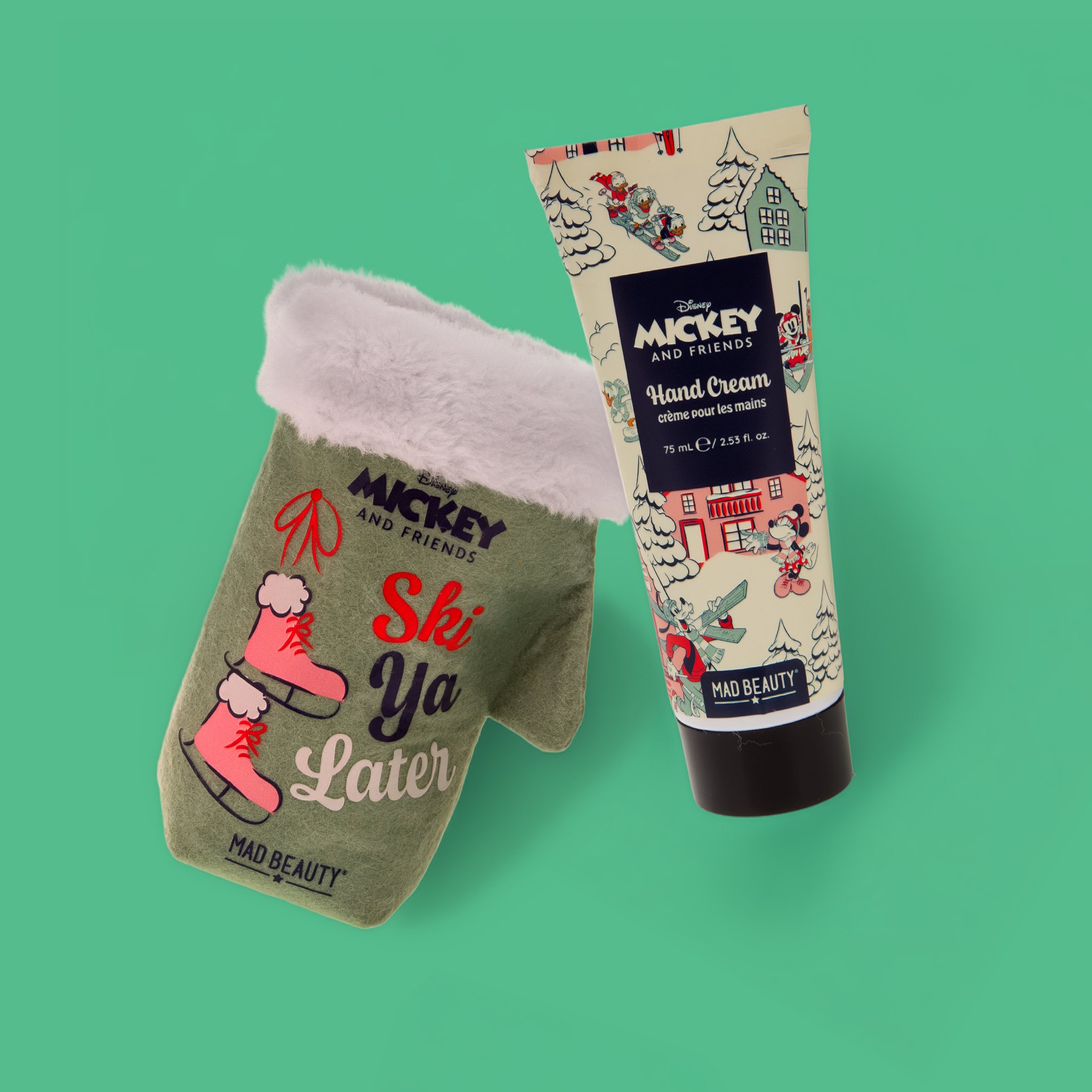 Mickey Handcreme neben dem Filz-Fäustling «Ski Ya Later» mit Plüschrand, grüner Hintergrund