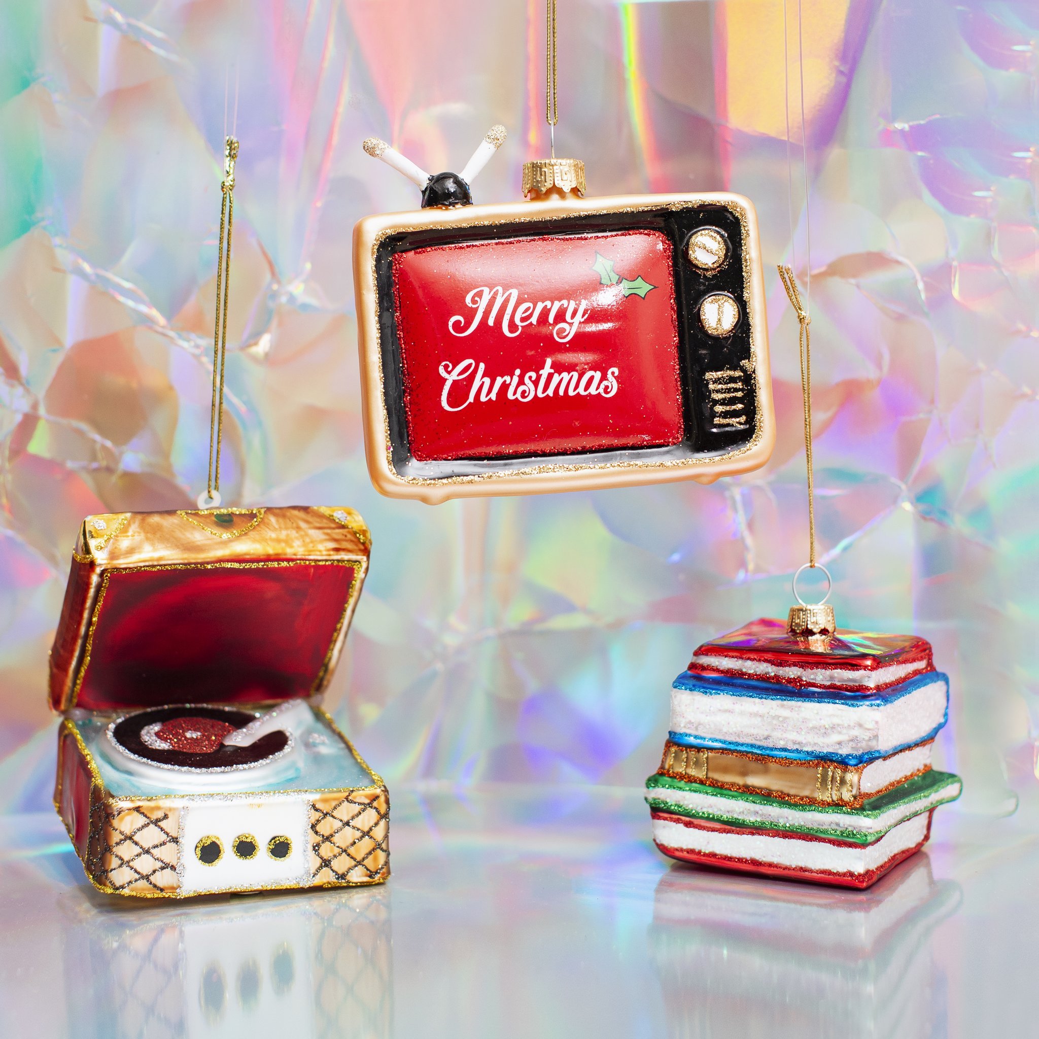 Glass record player beside other retro decorations on a shimmering backdrop
