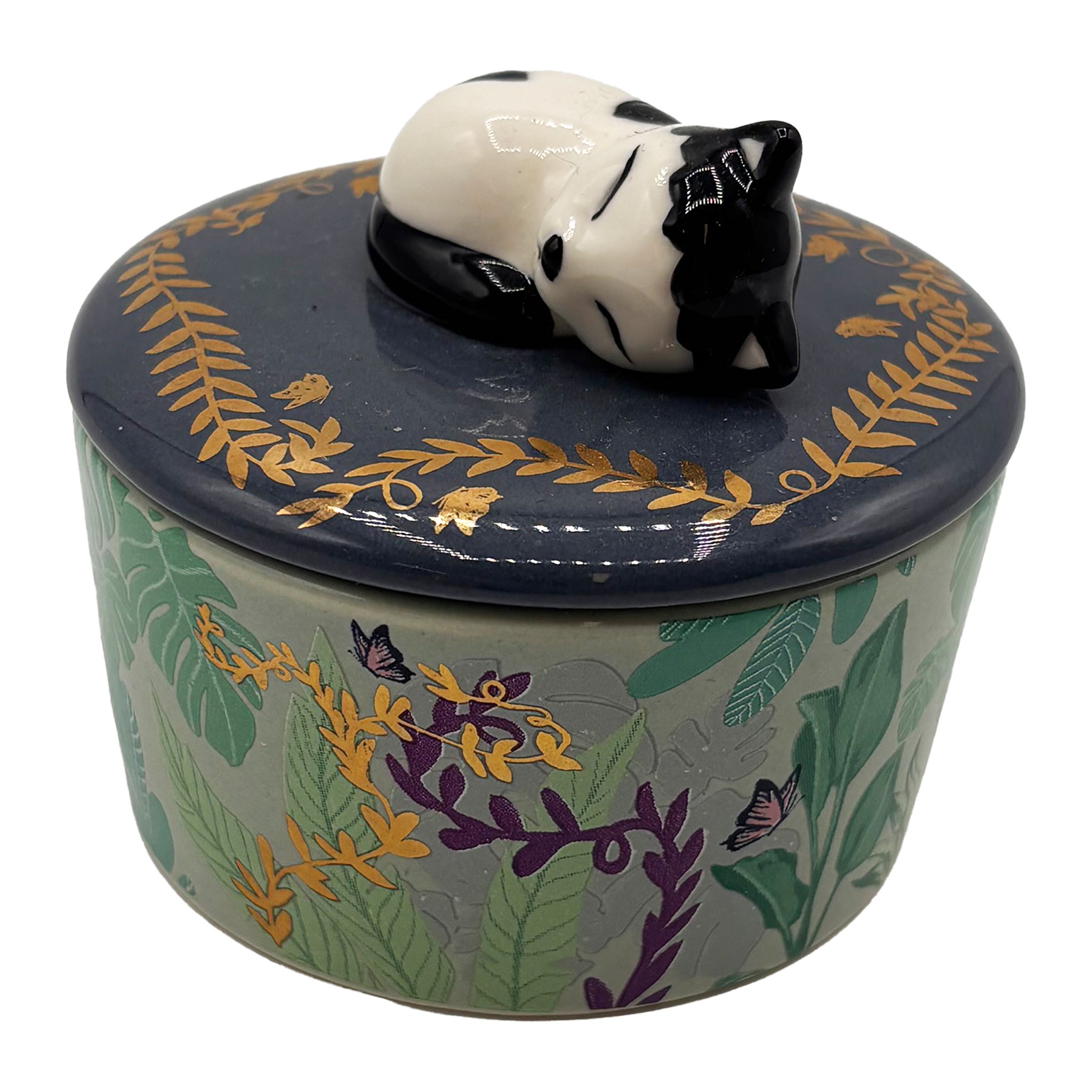 Cat trinket pot at an angle from the front, leaf pattern and purple blossoms on the pot