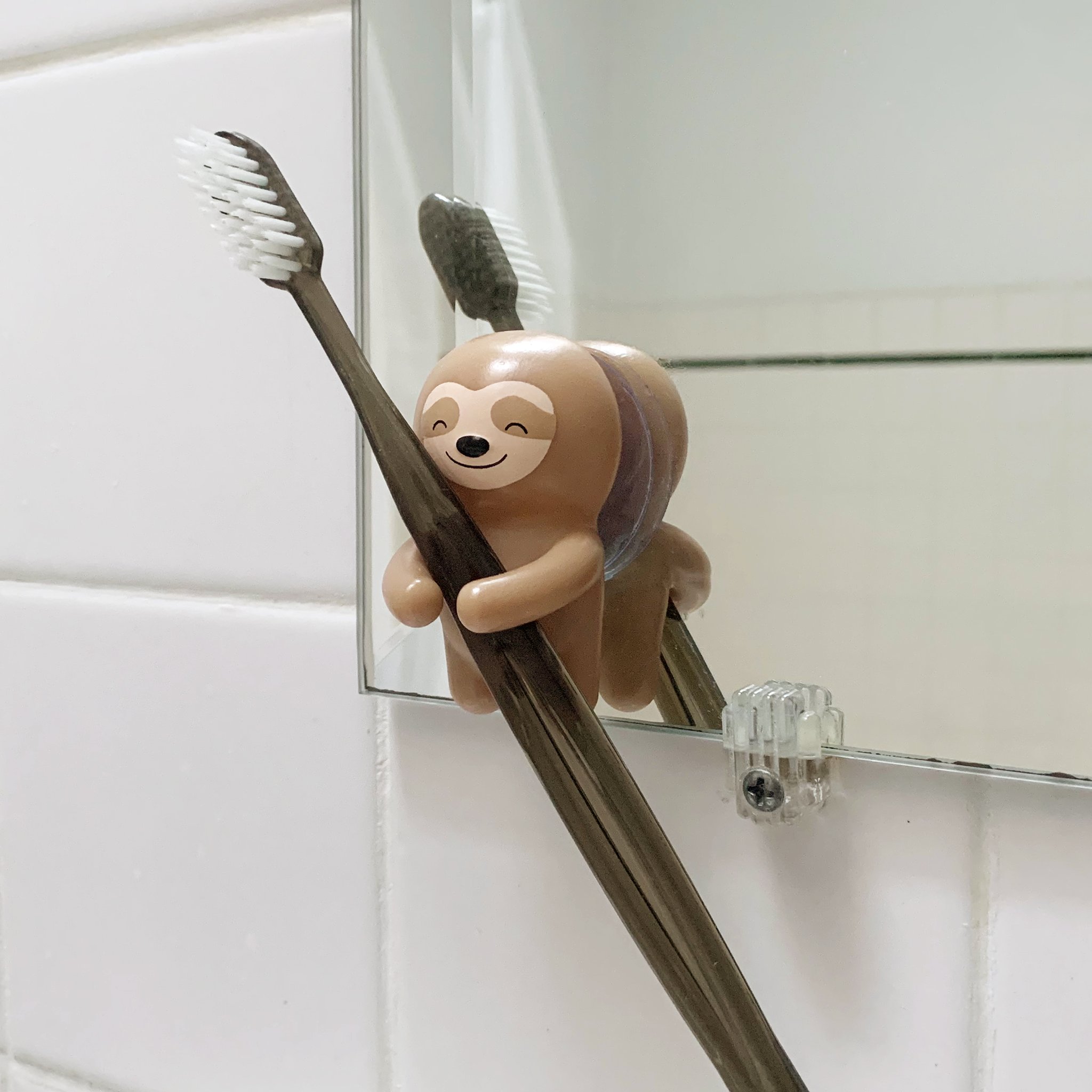 Kikkerland Sloth Toothbrush Holder – mounted on mirror with toothbrush