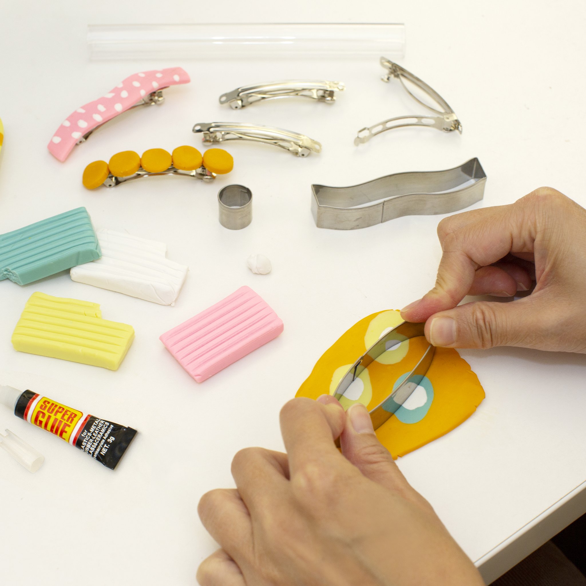 DIY hair clip set: hands cutting the clay with the cutter