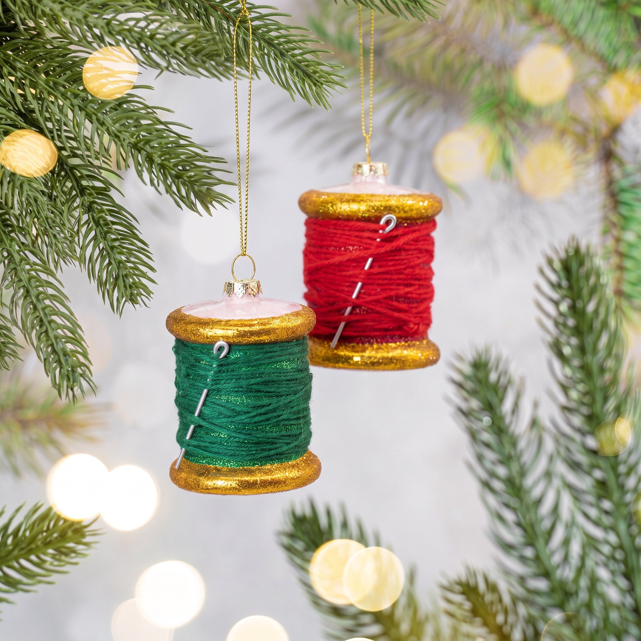 Thread Spool Christmas Bauble by Sass & Belle on a fir branch with warm fairy lights