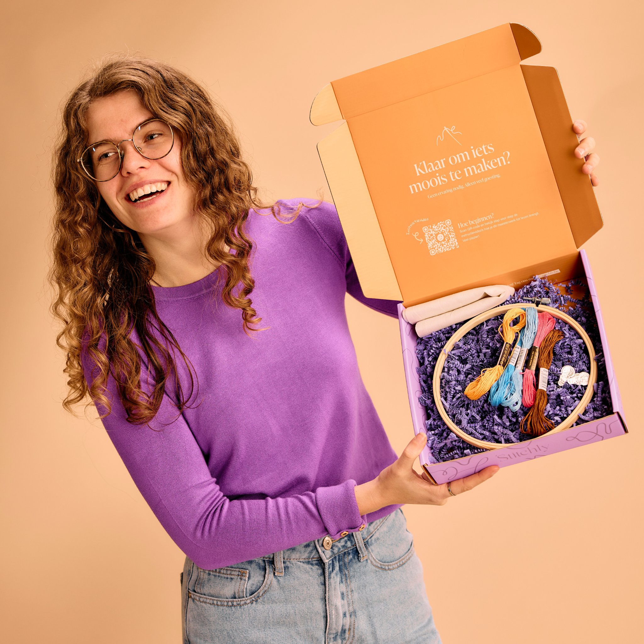 Lavender Bouquet Embroidery Kit with Hoop by Stitchly – woman presenting the opened embroidery kit