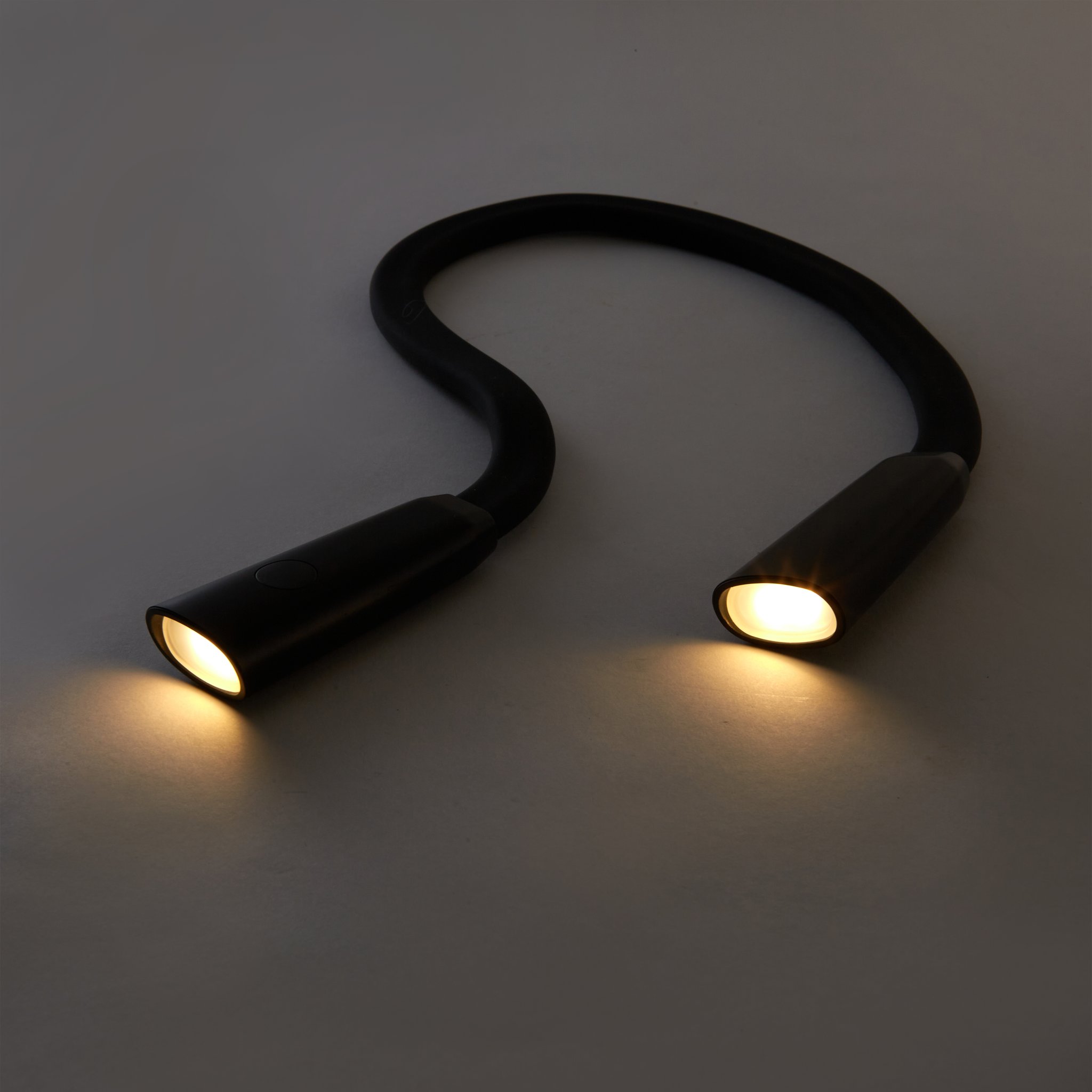 Neck reading light glowing in the dark