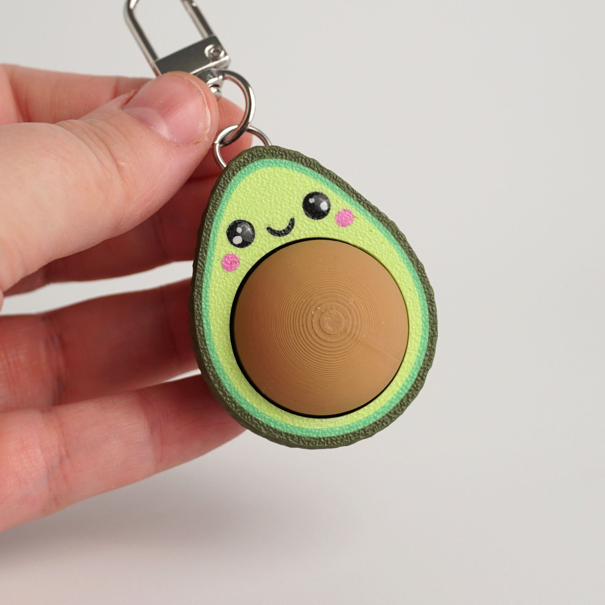 Tukitsu Avocado Clicker Schlüsselanhänger — Rückseite brauner Kern
