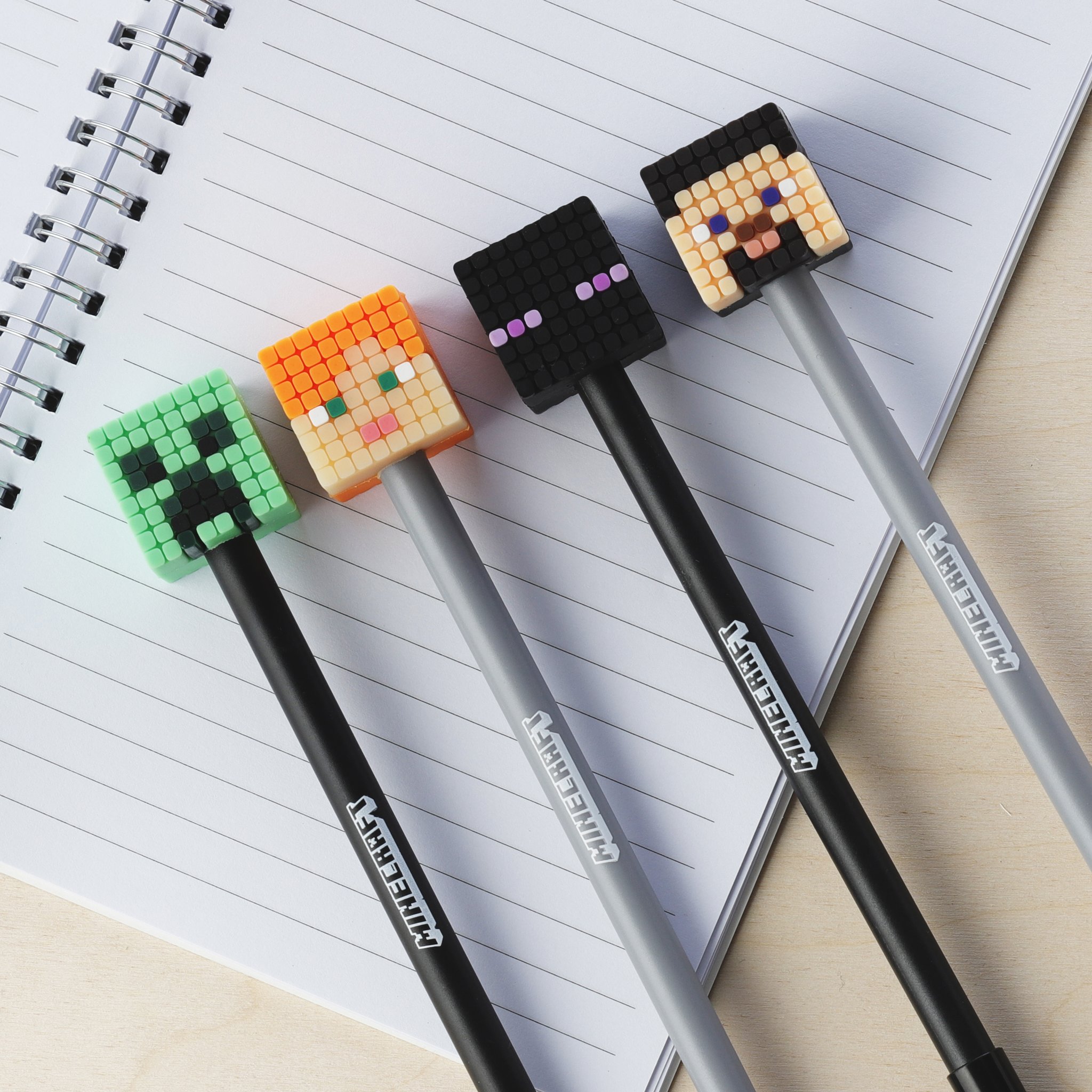 Four Minecraft fineliners on an open notepad