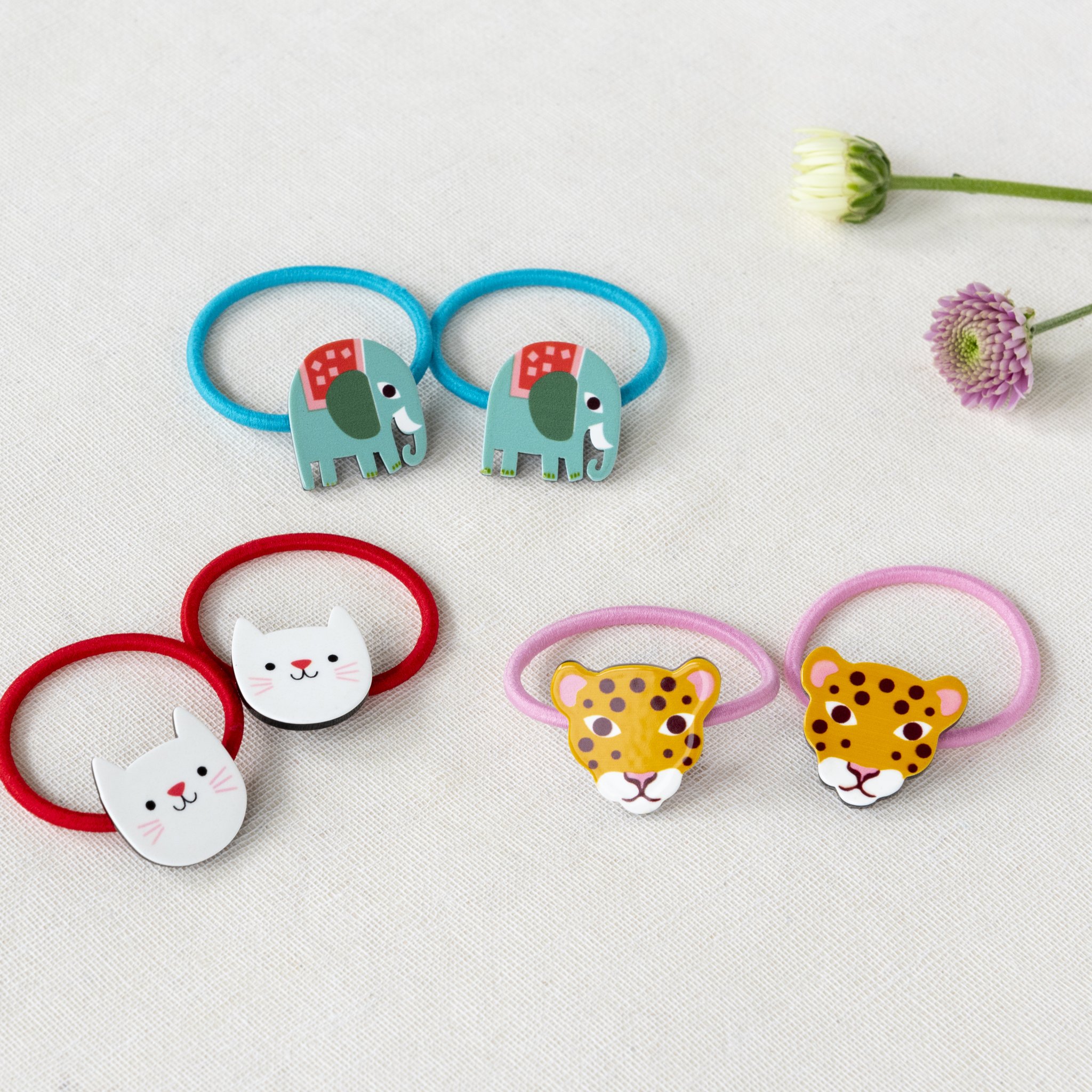 Cookie the Cat hair ties next to the elephant and leopard hair ties of the range